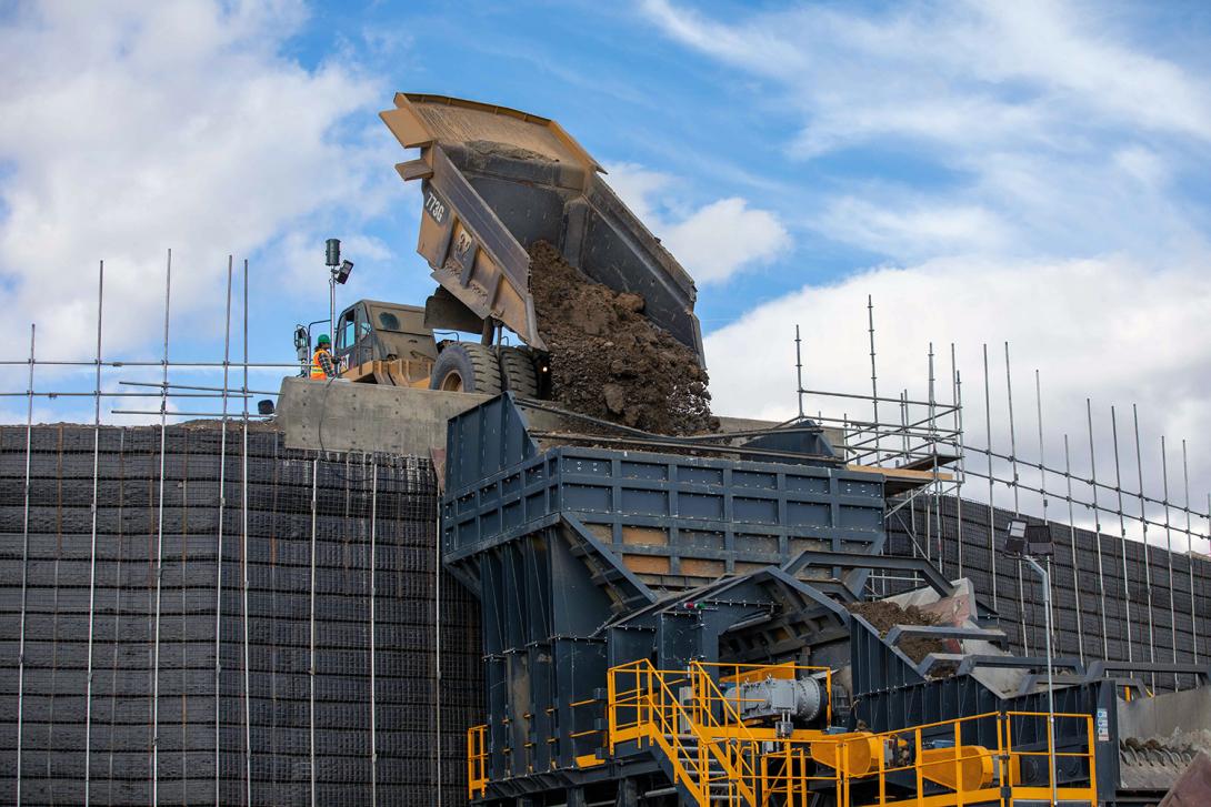 Glacial till is dumped into the hopper to feed the conveyor for transport to site. | September 2021