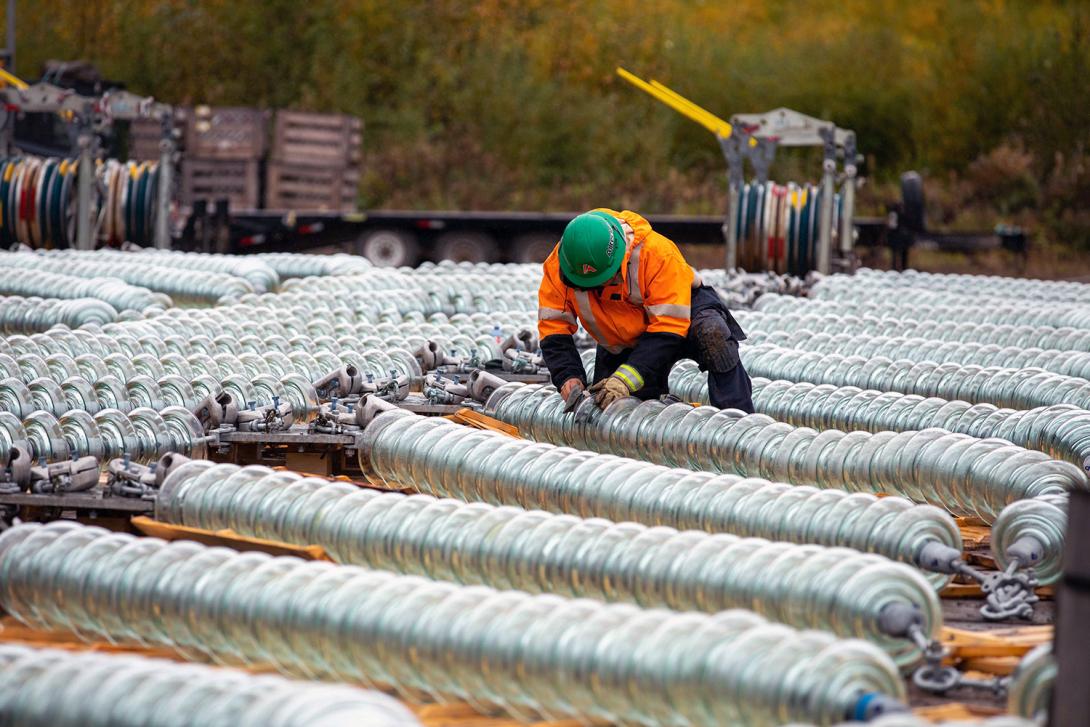 Crews clean and inspect insulators in the helicopter fly-yard prior to installation. | September 2021