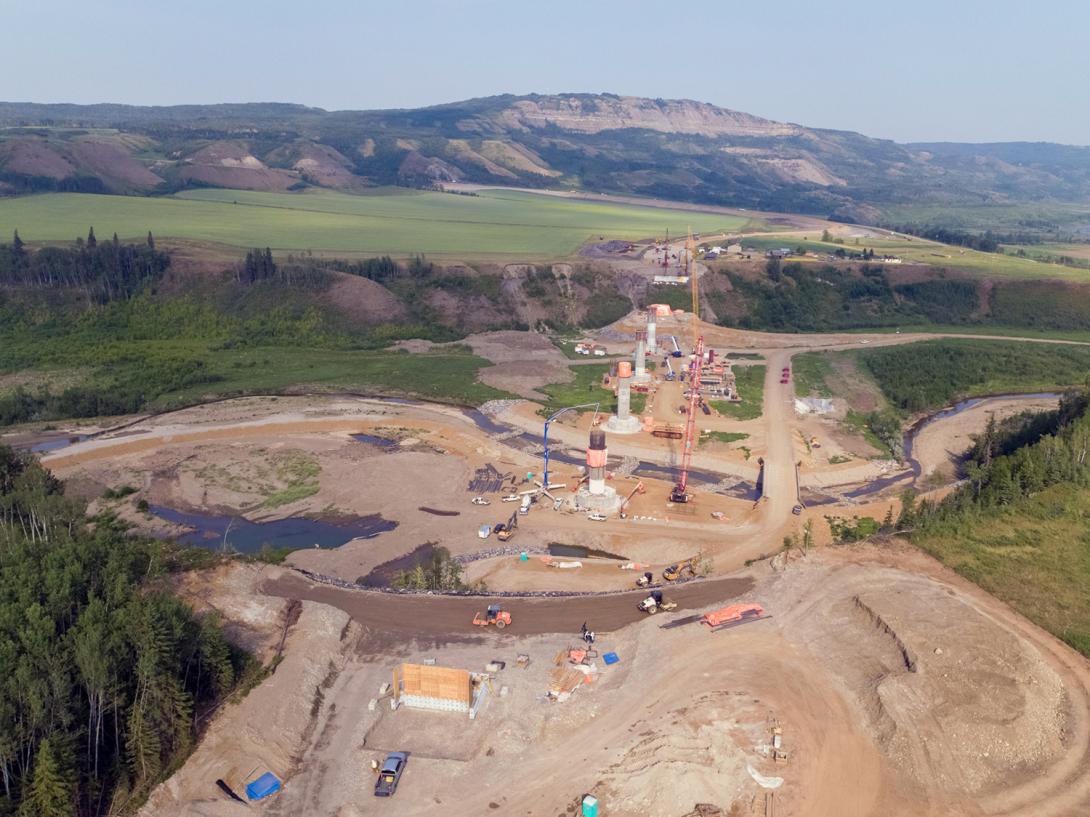 Highway 29 alignment at Cache Creek in varying stages of construction, showing the abutments at both ends of six bridge piers. | July 2021