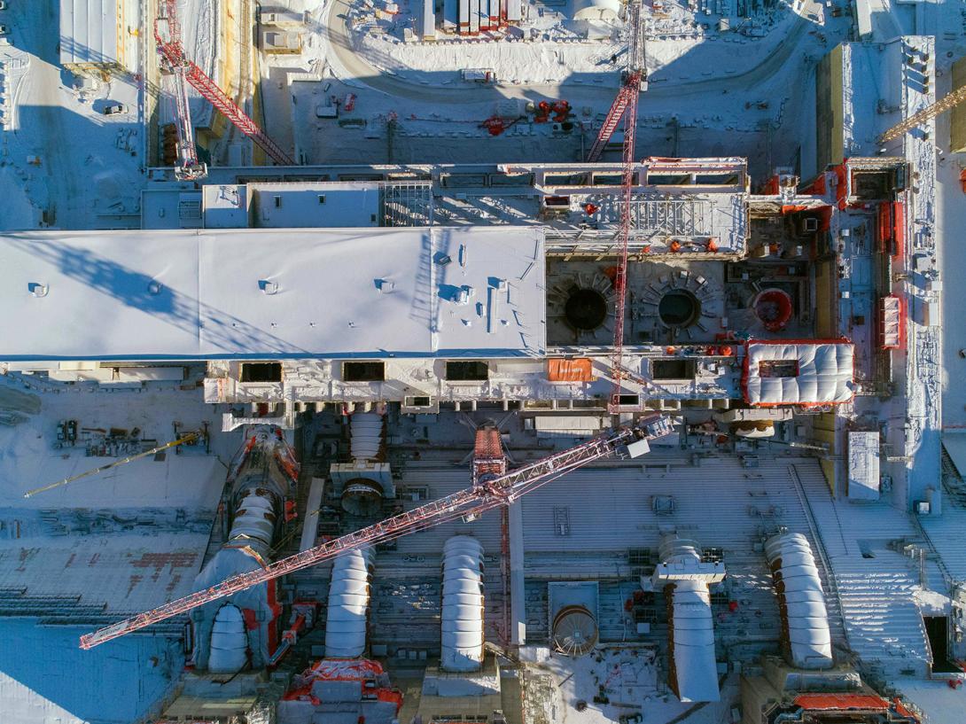 Aerial view of five of six penstocks under construction. A penstock is a large steel pipe in a hydroelectric generating station that brings water from the reservoir to a turbine. | February 2021