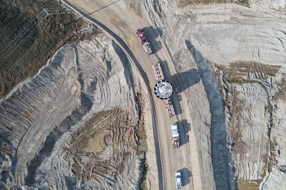 Aerial view of the 165-tonne turbine runner being transported to the powerhouse. | October 2022