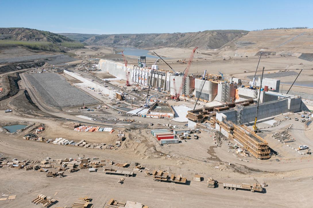 Upstream view of the approach channel, generating station, and spillways. | May 2023