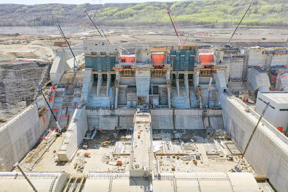 Two mechanical spillways, operated with gates, will manage flows from the reservoir. The auxiliary spillway is on the left. | May 2023
