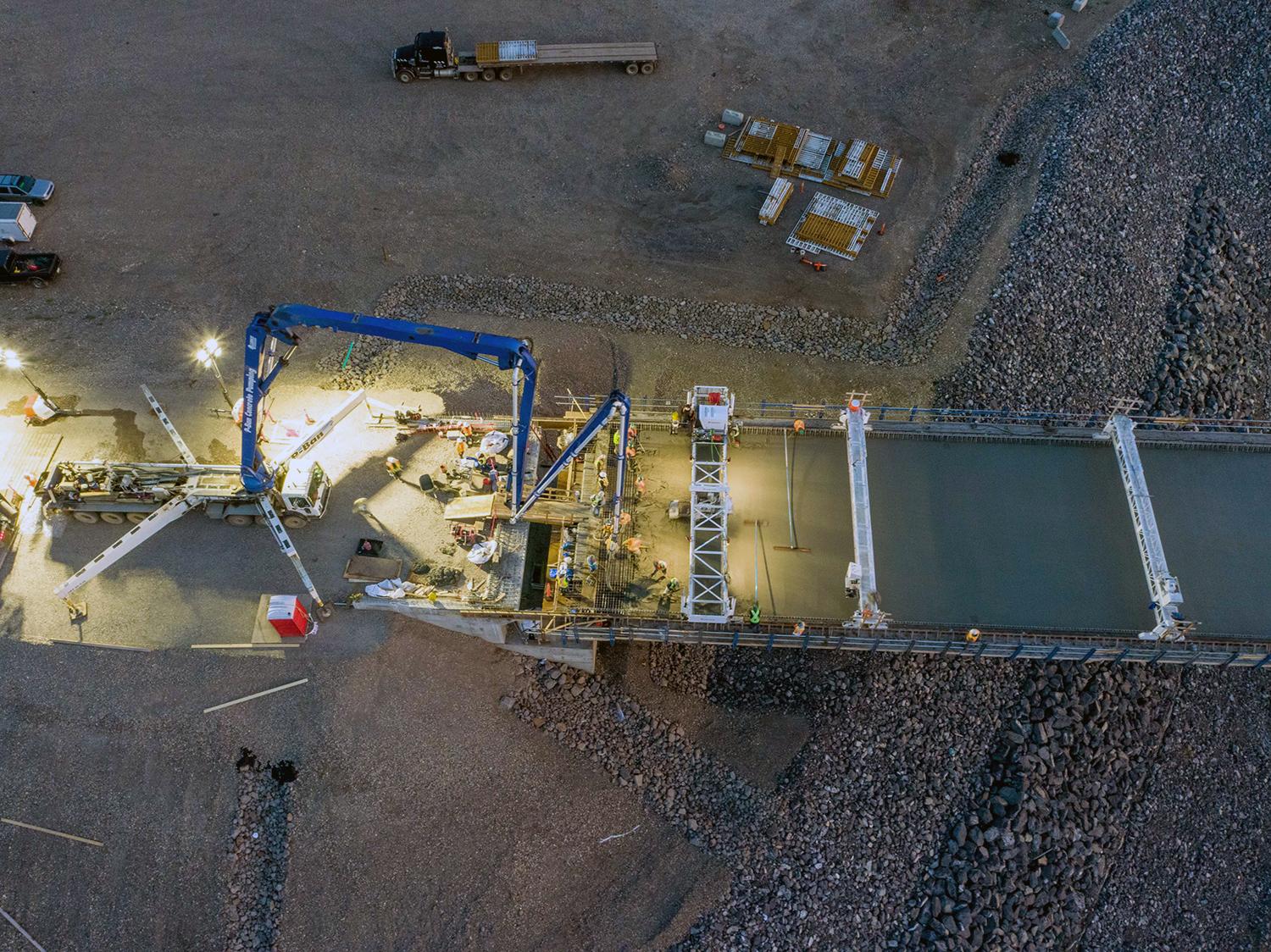 The concrete needed for the Halfway River bridge is made at site and transported to the bridge where it is pumped onto the bridge deck. | August 2021