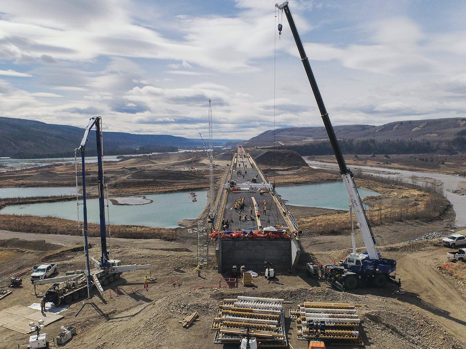 Preparing the Halfway River bridge deck for the first concrete placement on April 29. Concrete is placed using a concrete pump truck and then levelled with a screed machine, which moves on rails to level the concrete to the correct thickness and slope for the deck. | April 2021