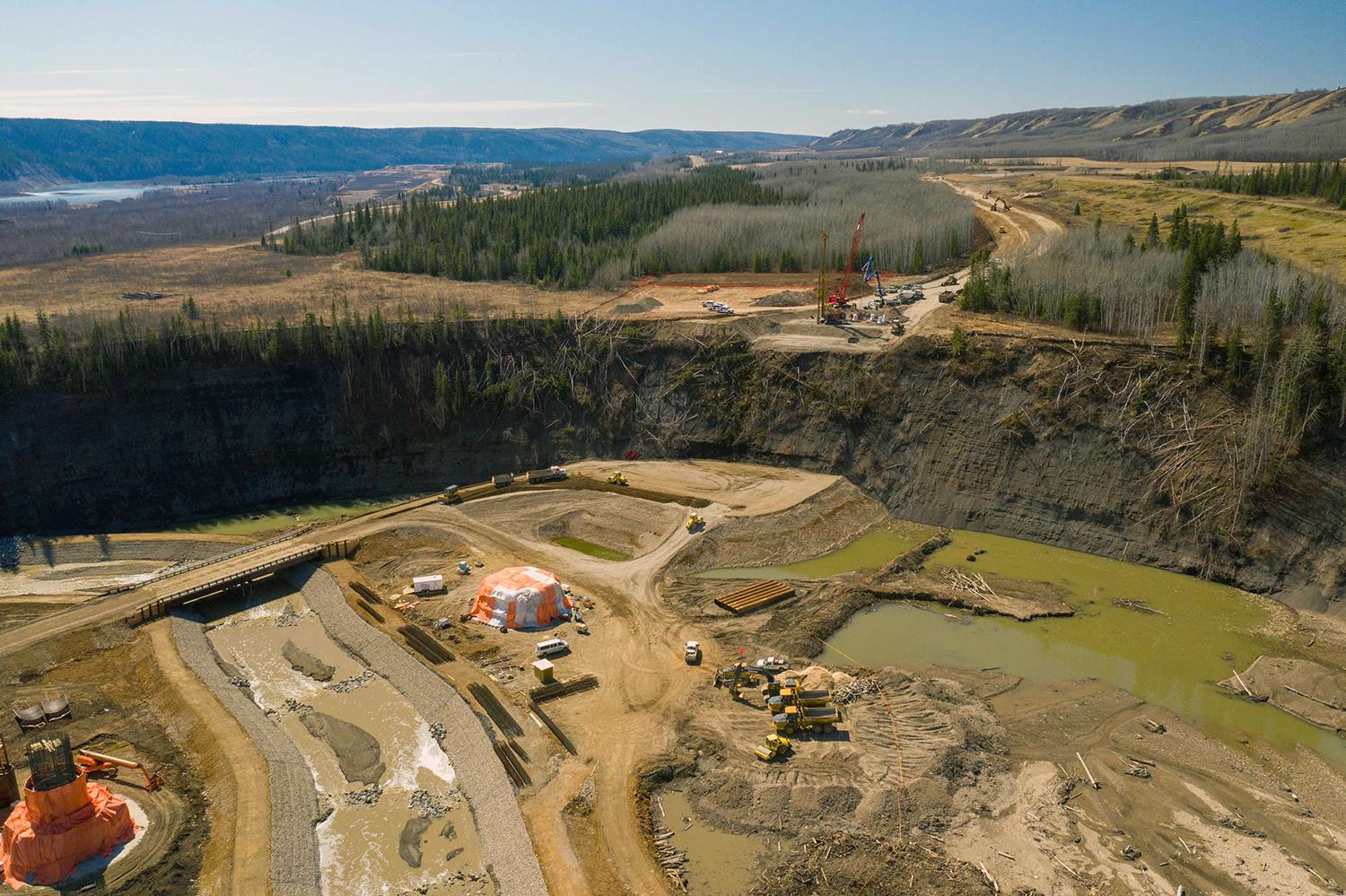 Crews work on the west abutment of the new bridge over Cache Creek as part of Highway 29 realignment activities. | April 2021