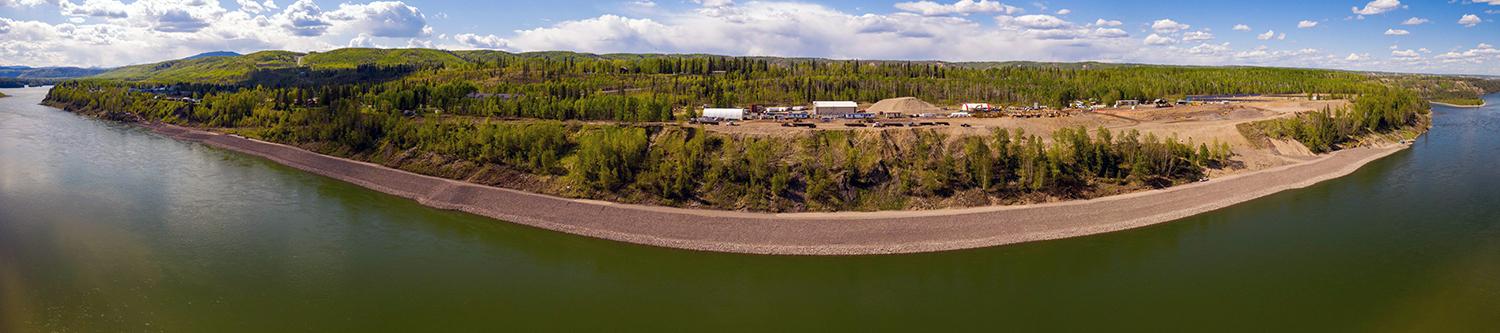 The construction of a 2.6-kilometre-long berm to protect the shoreline of Hudson's Hope is underway. Crews are clearing vegetation and placing material along the shoreline to build the berm. | May 2021