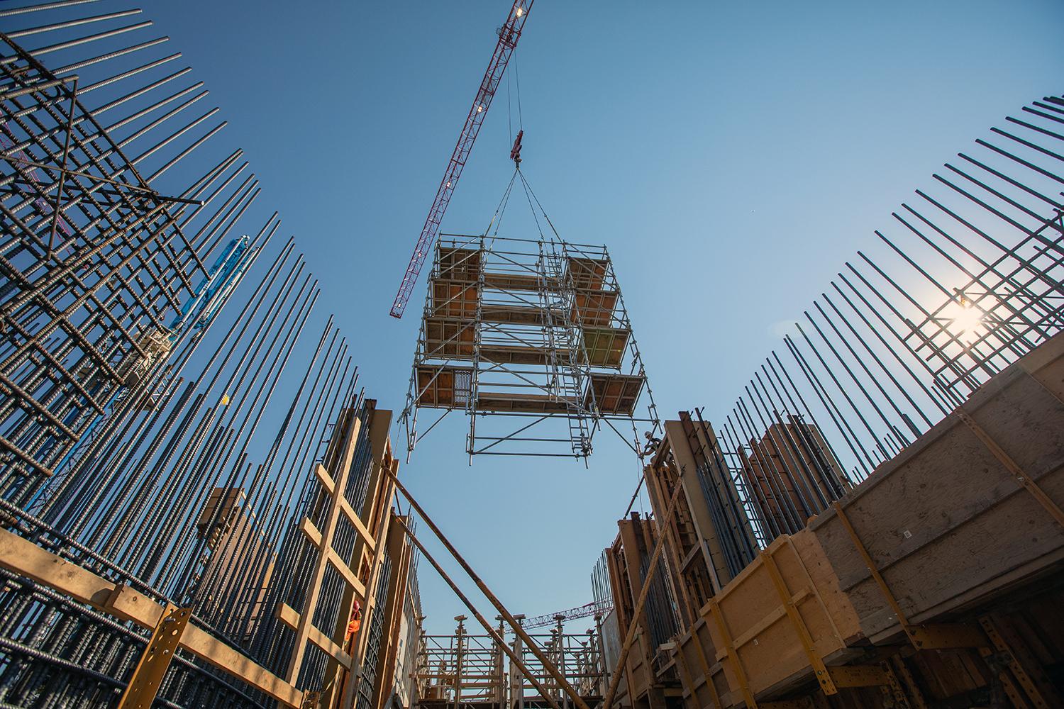 Installing scaffolding at the spillway headworks low-level outlet. | July 2021