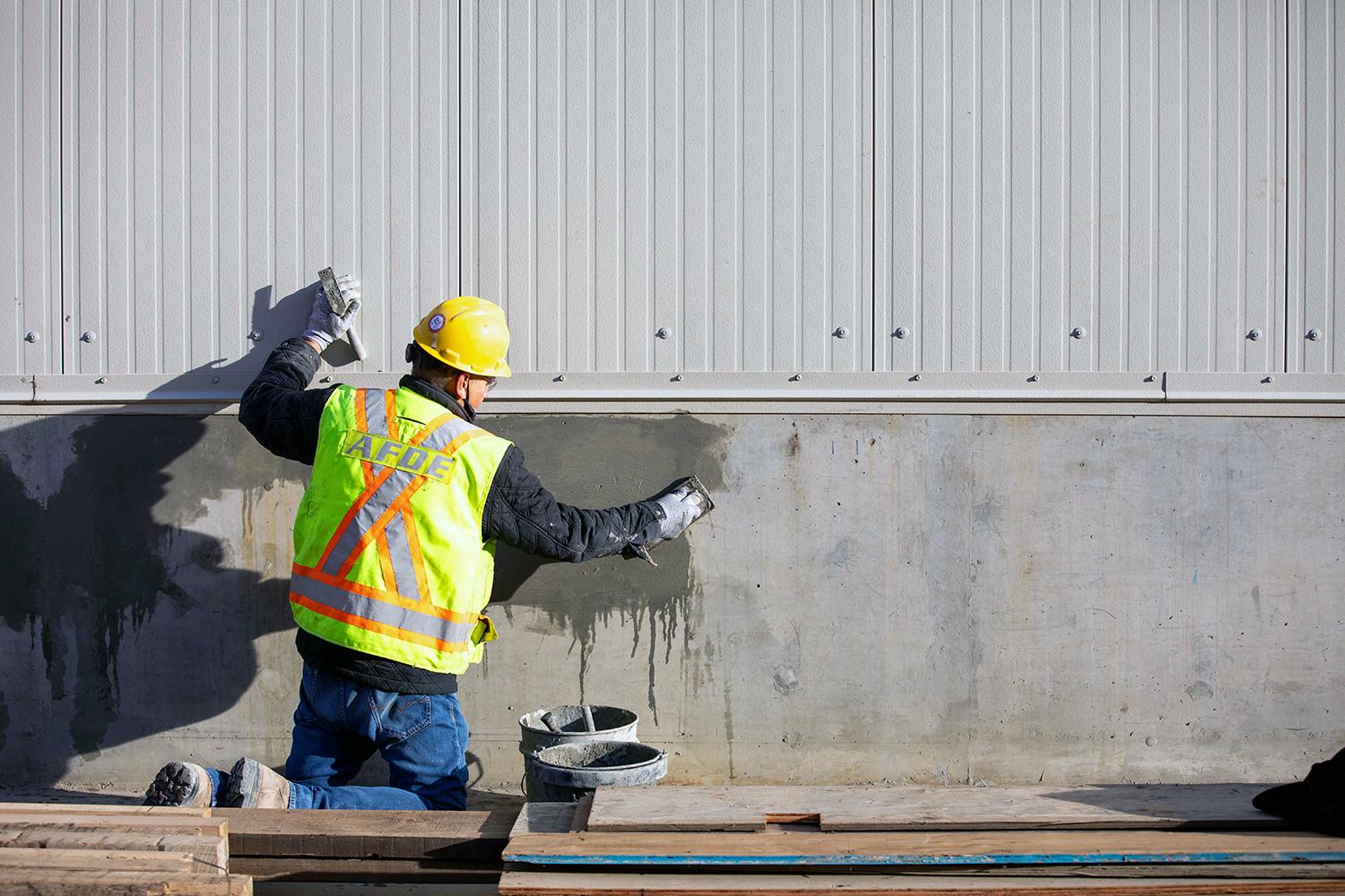 Concrete finishing on the outside wall of the powerhouse. | October 2021