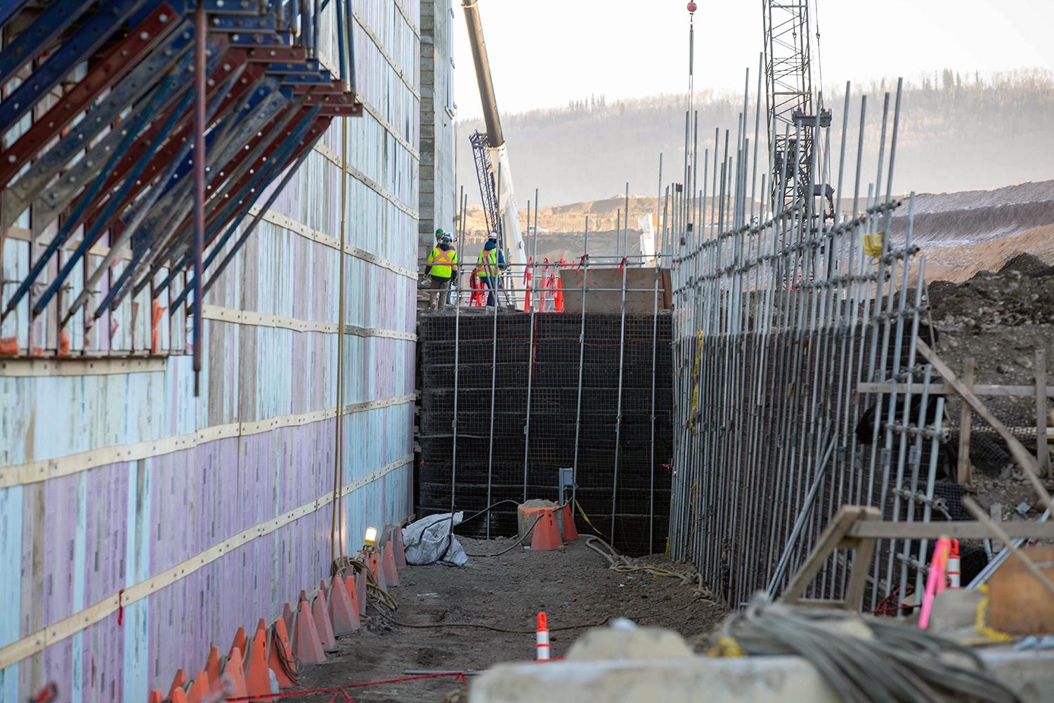 Dismantling the temporary access ramp to the dam and core buttress that was used for roller-compacted concrete placement.