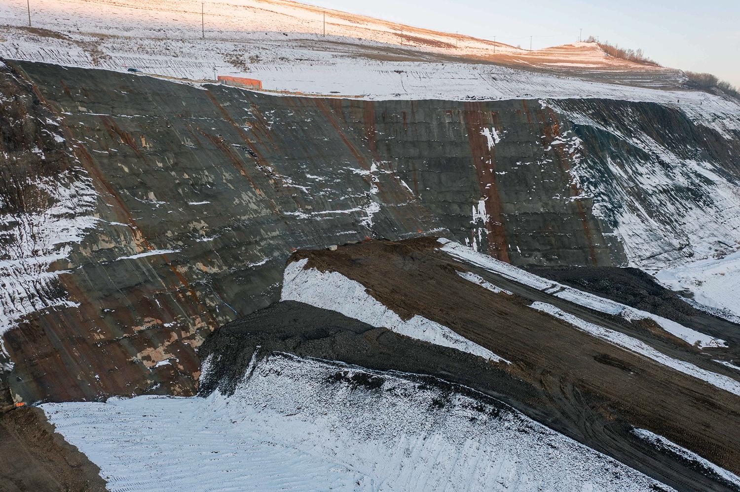 A side view of the temporary access ramp at the left core trench abutment that allows equipment to grout the higher elevations of the abutment.