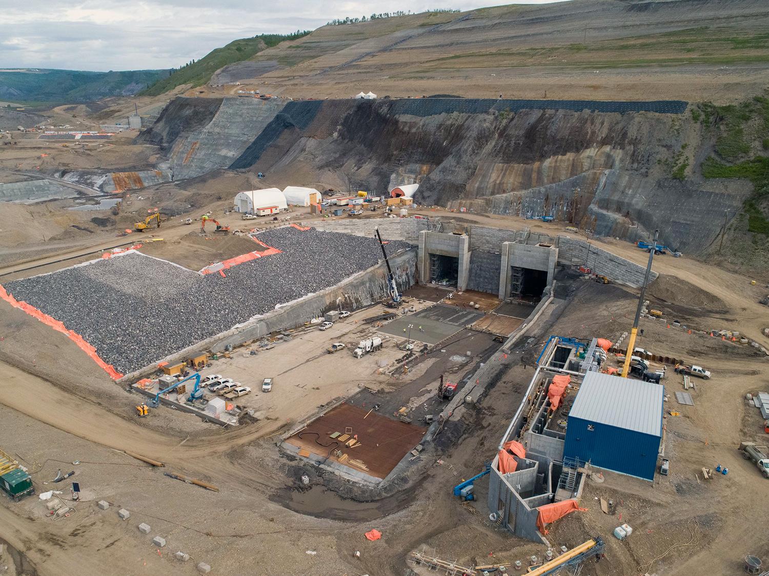 The completed diversion tunnels outlet portals on the north bank and temporary fishway (pictured lower right) nearing completion. | May 2020