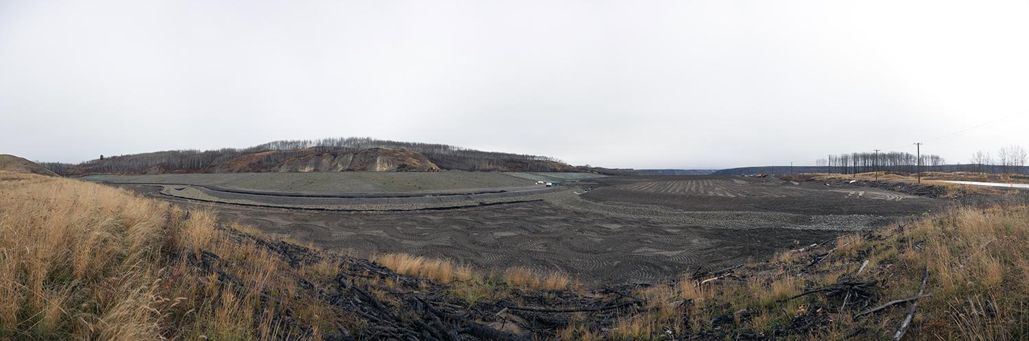 View of a completed slope in a laydown area on the north bank, with silt fencing installed and hydro seeding completed to prevent erosion | October 2017