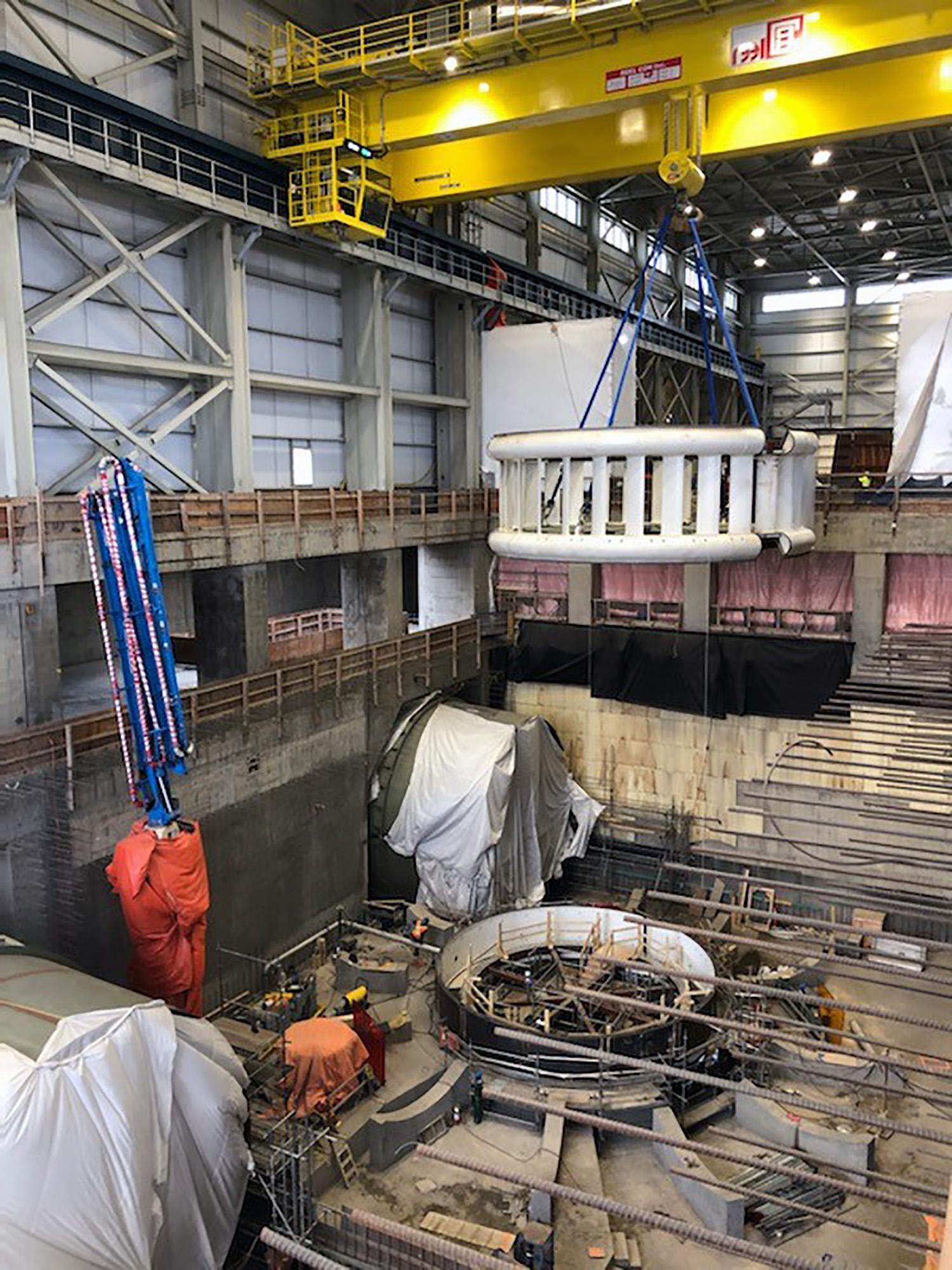 The Unit 1 stay ring is lowered into place using a crane. | February 2021