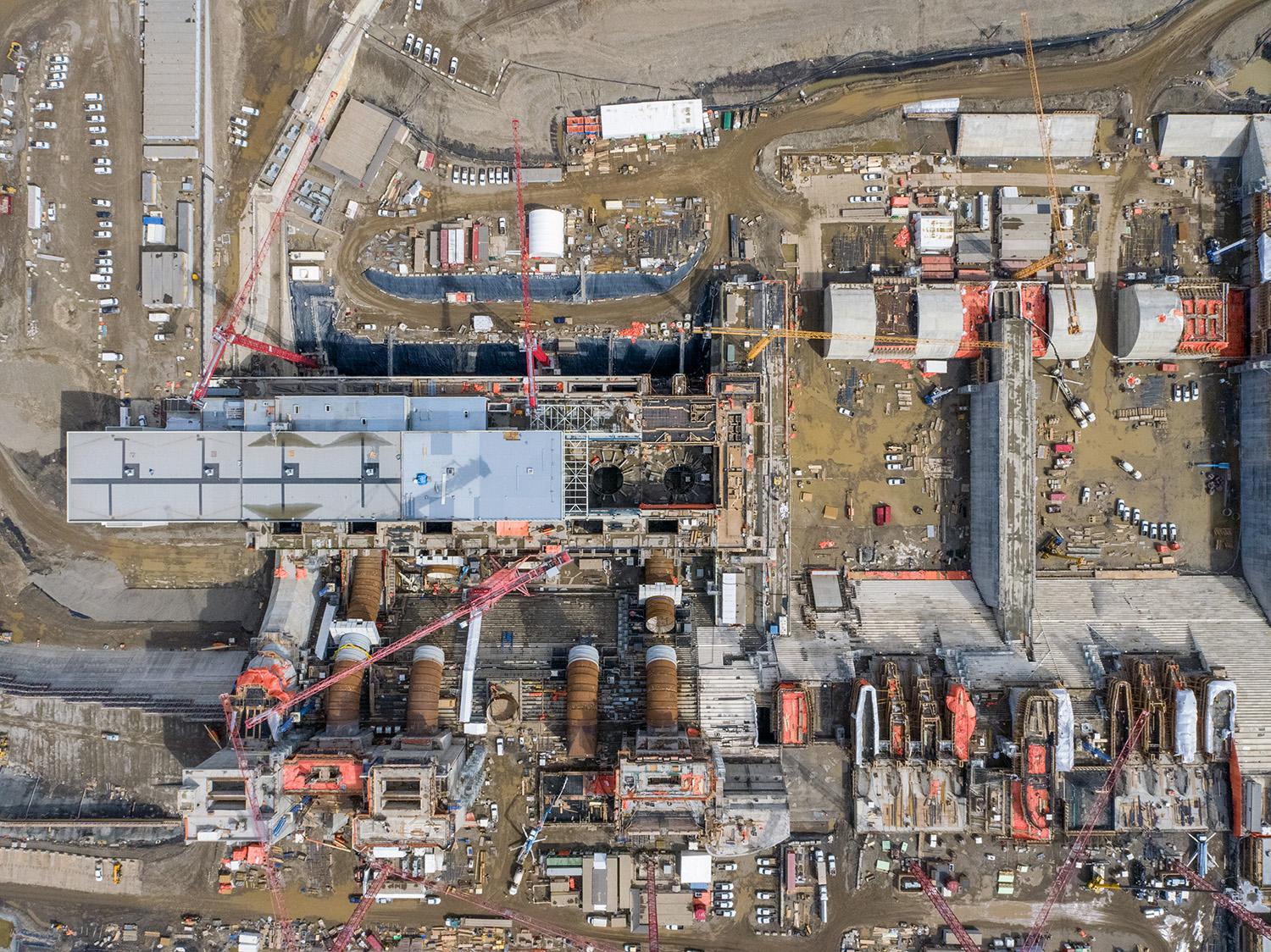 Overhead view of the Site C generating station and spillways. | April 2021