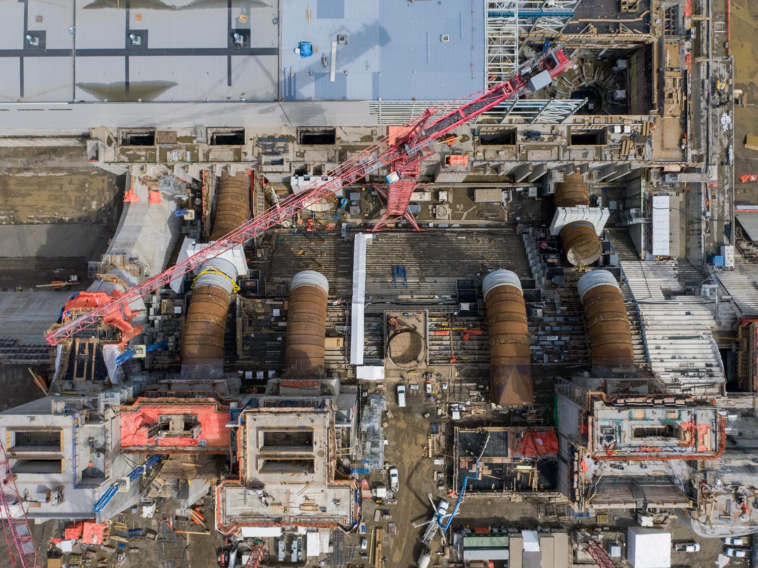 An aerial view shows the six Site C intakes and penstocks in varying stages of construction. | April 2021