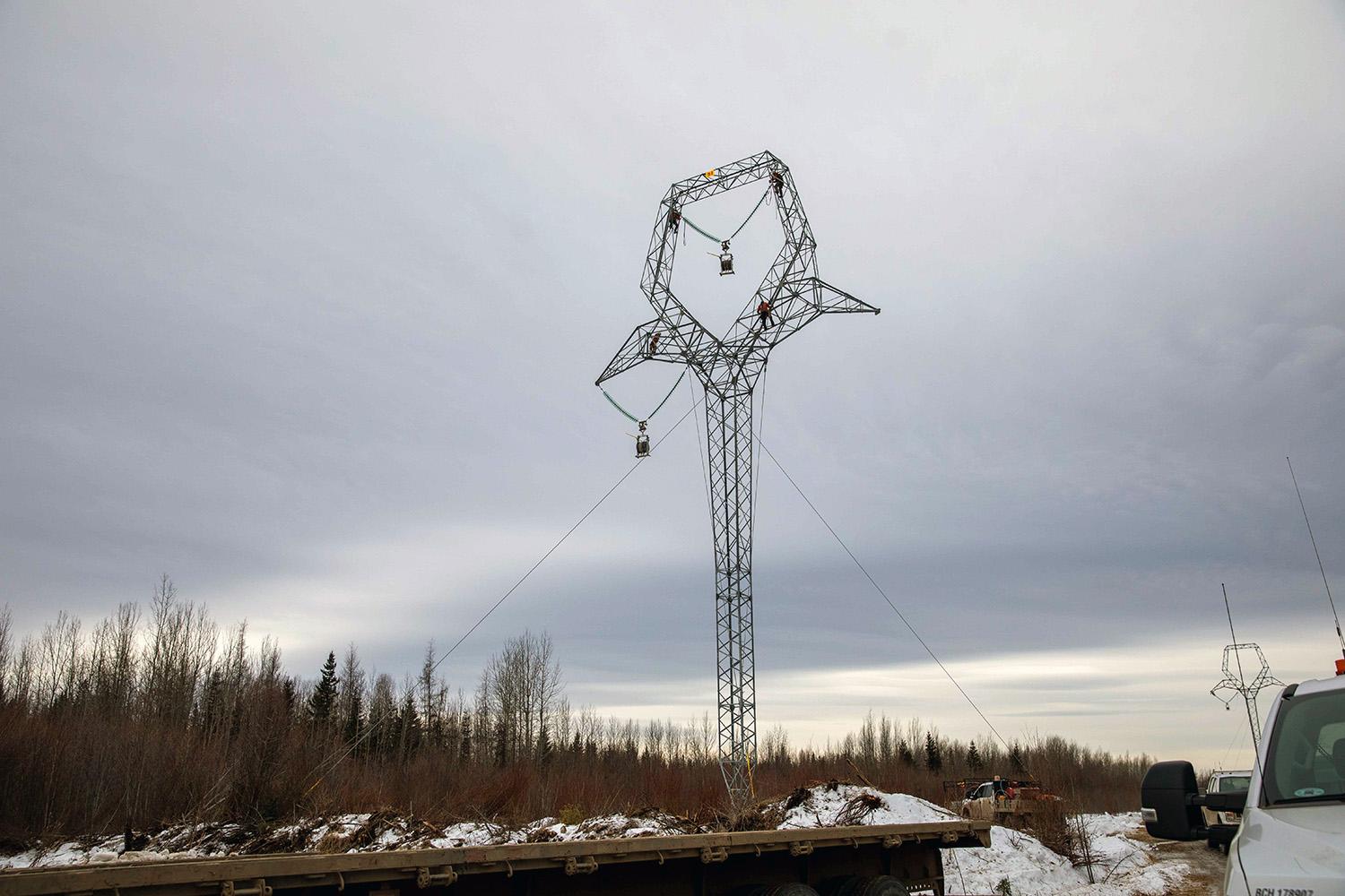 The tower crew climb a tower to receive the insulator assembly. | January 2022