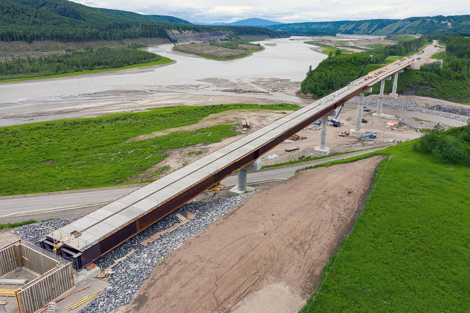 Concrete is poured on Farrell Creek Bridge for the abutment, while the crews complete deck panels and formwork on the west end of the bridge. | June 2022