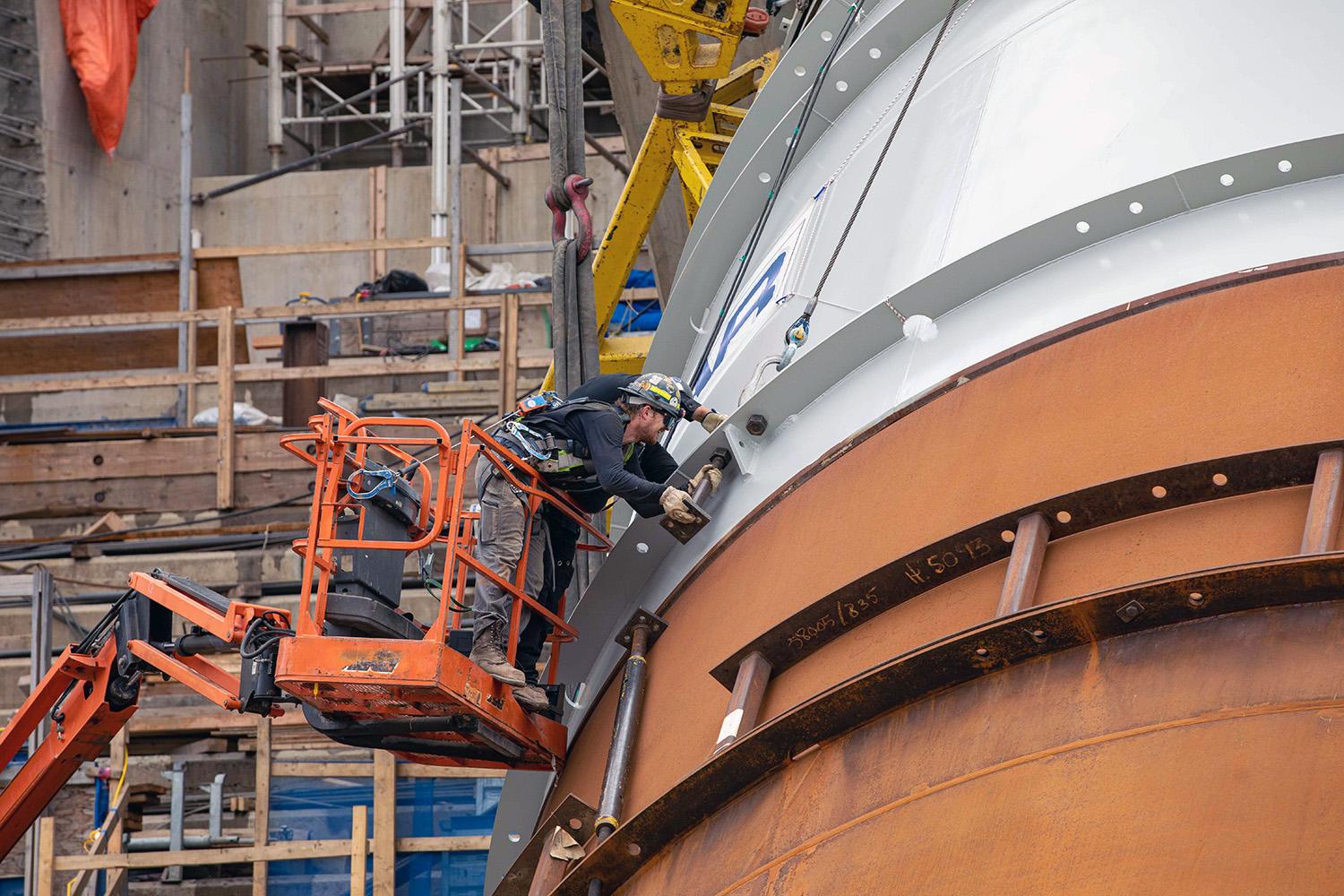 Welding penstock segments together. | June 2022