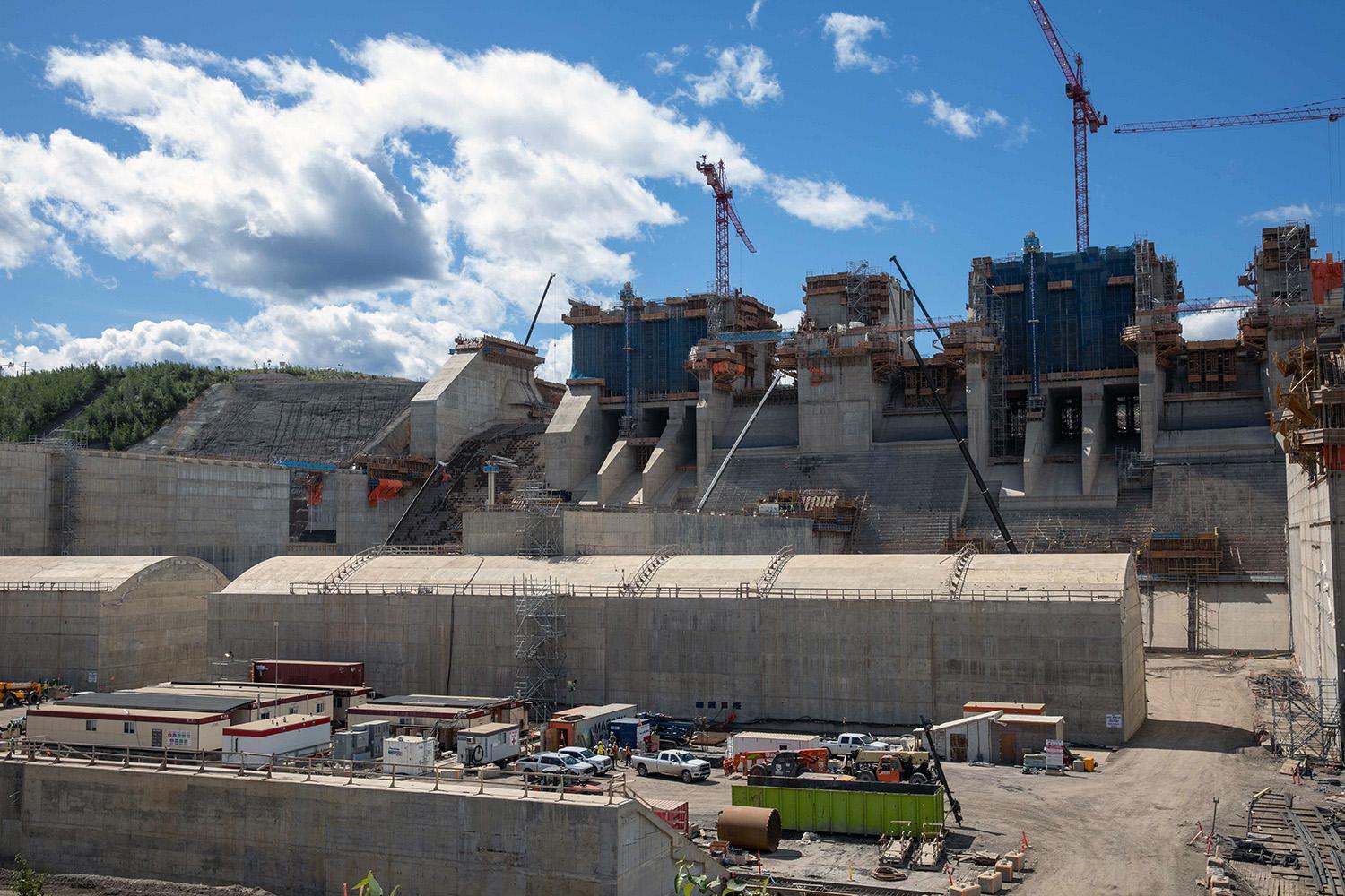 Construction of the spillway upper headworks and stilling basin. |July 2022