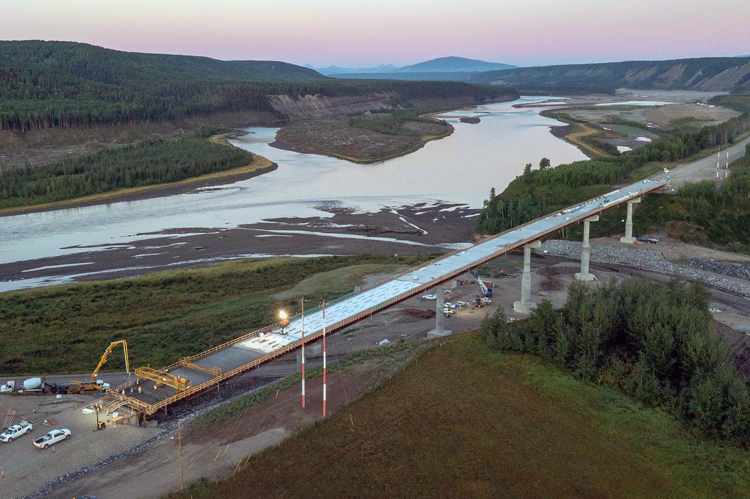 A concrete pumper pours concrete to lay the final layer on the Farrell Creek Bridge deck. | August 2022