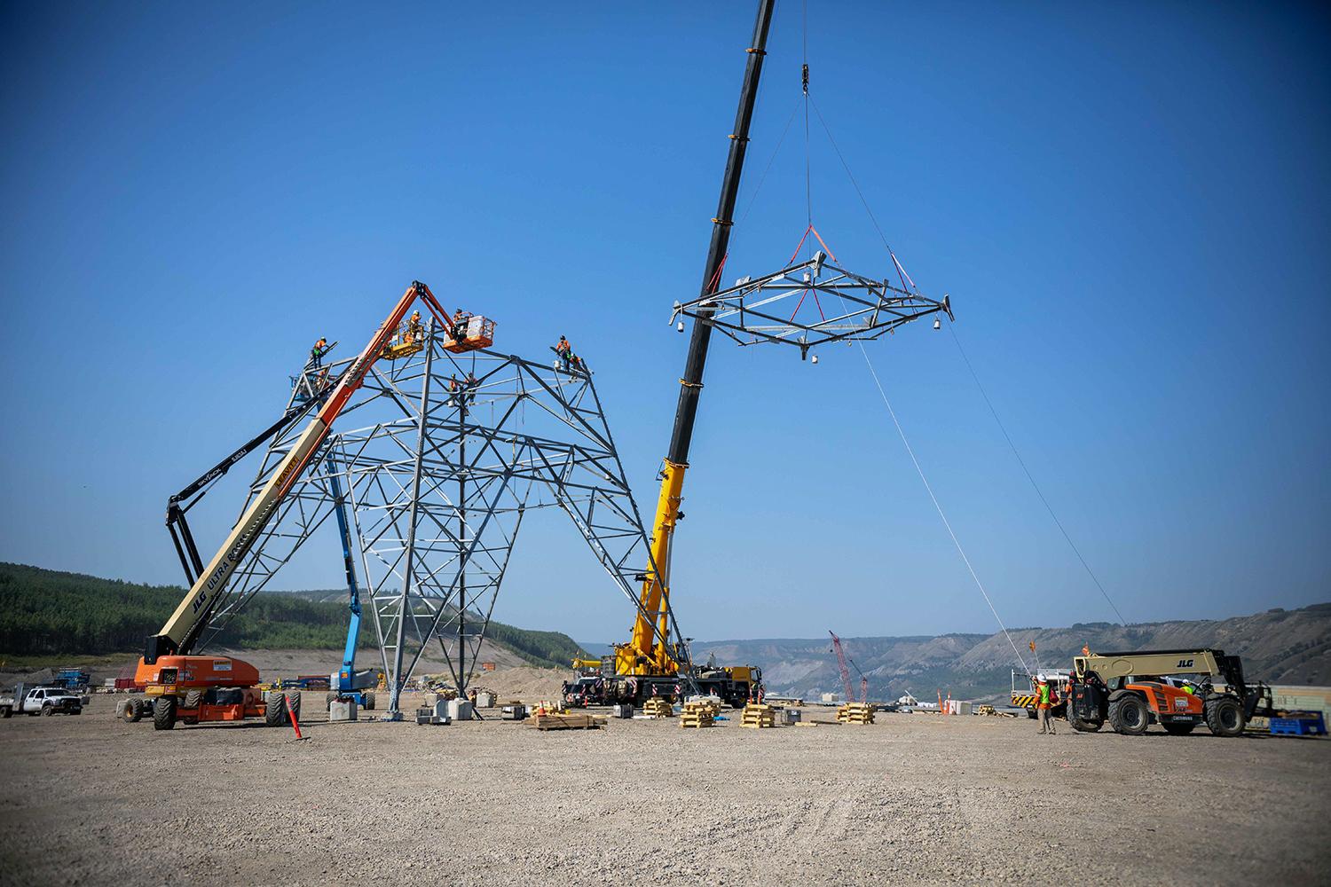 A crane lifts the tower segment into position so it can be attached. | August 2022