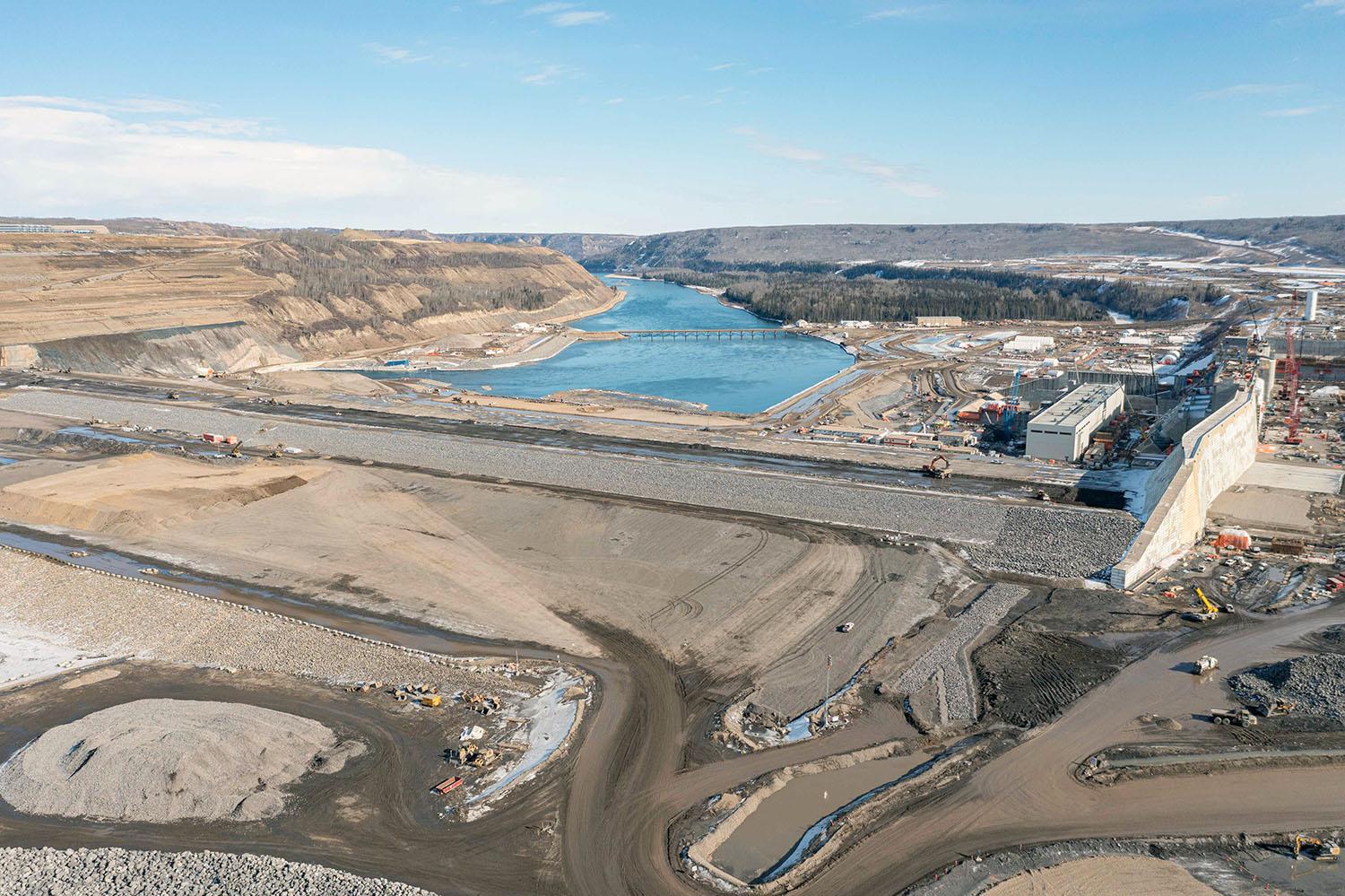 Water from the Peace River will flow down the approach channel on the far right and exit the Site C dam downstream. | March 2023