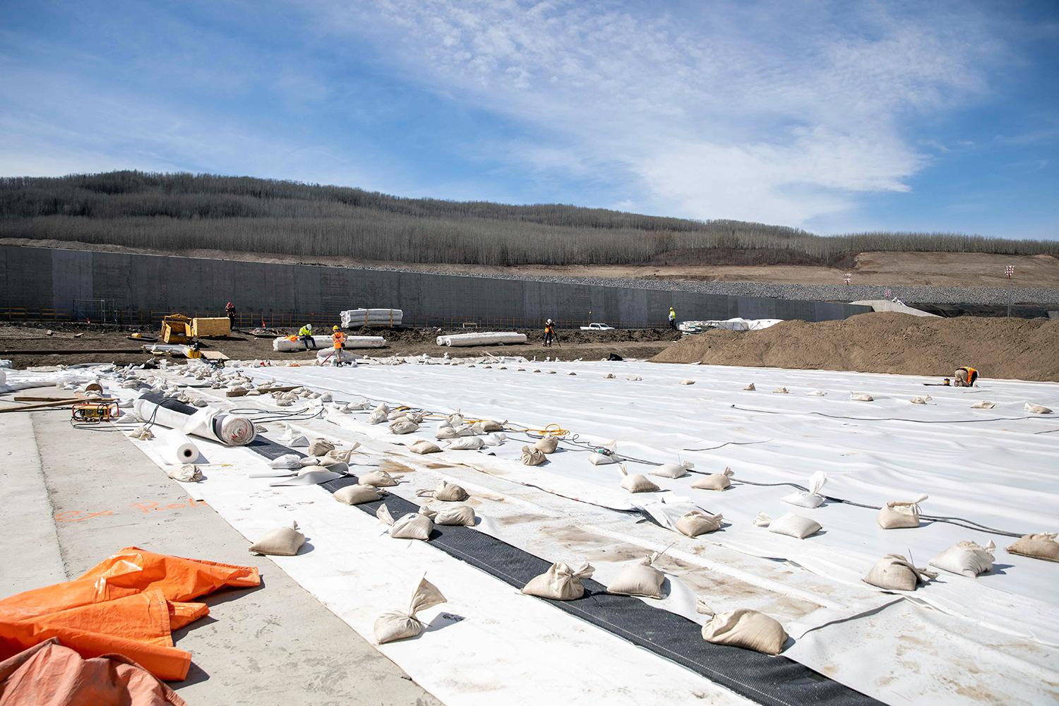 A waterproof membrane is being installed in the approach channel. | April 2023