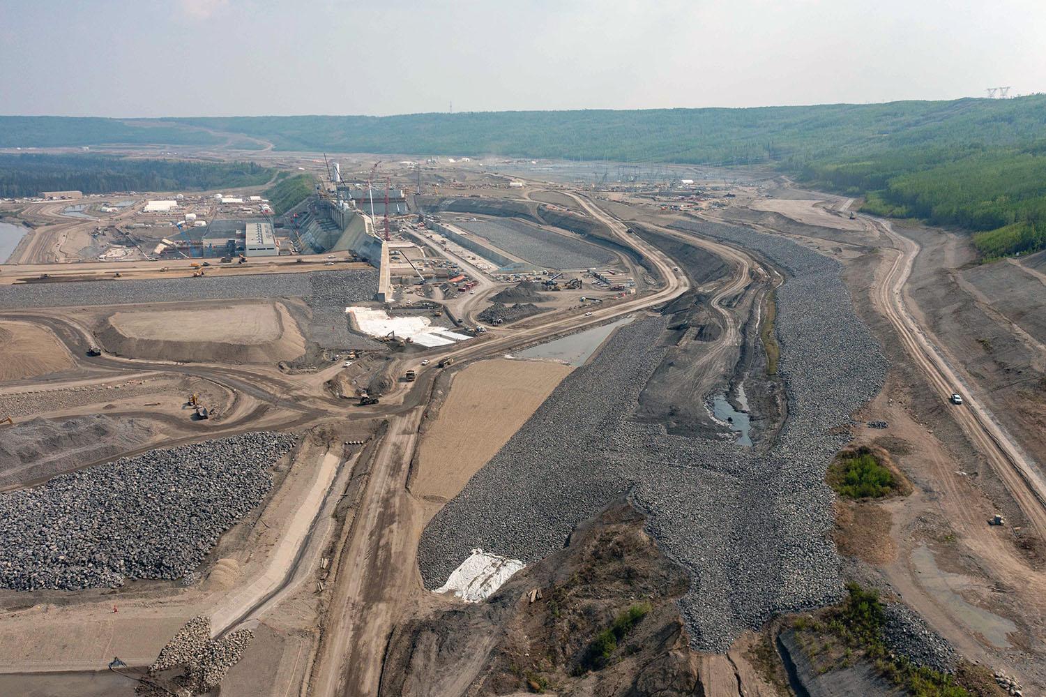 Downstream view of the approach channel. Water from the reservoir flows into the channel where it enters the intakes and drops down the penstocks into the turbine units and generates electricity. | May 2023