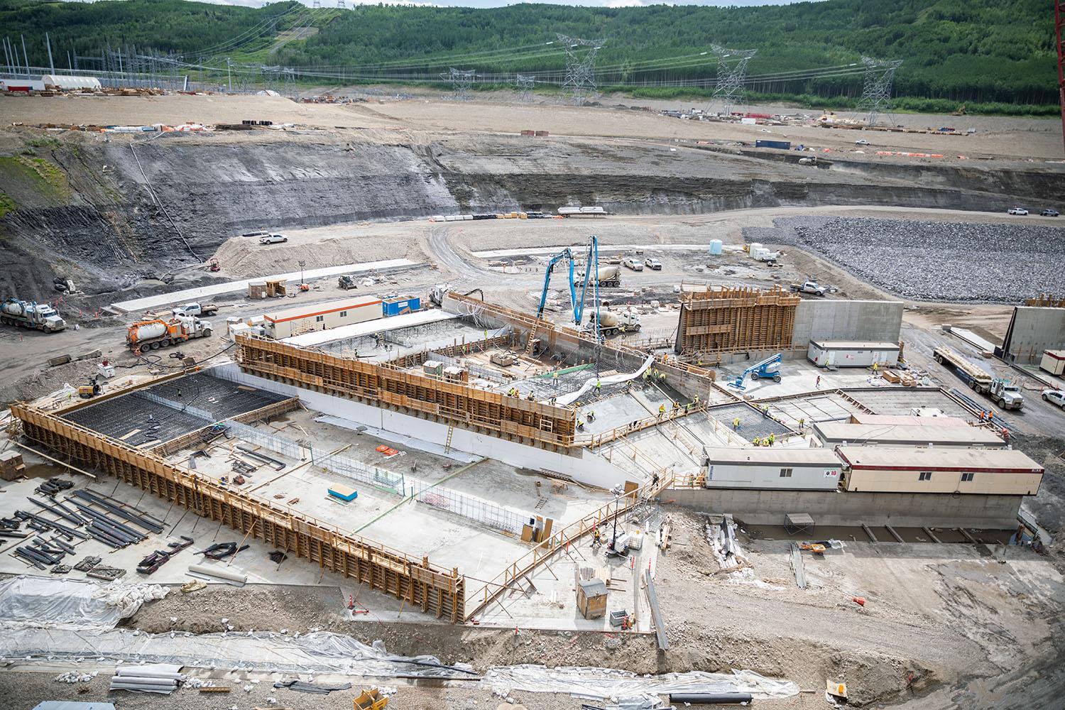 The east-end of the approach channel wall curves to divide the approach channel. Sections of the center wall are being formed and reinforcing steel placed to pour concrete. | May 2023