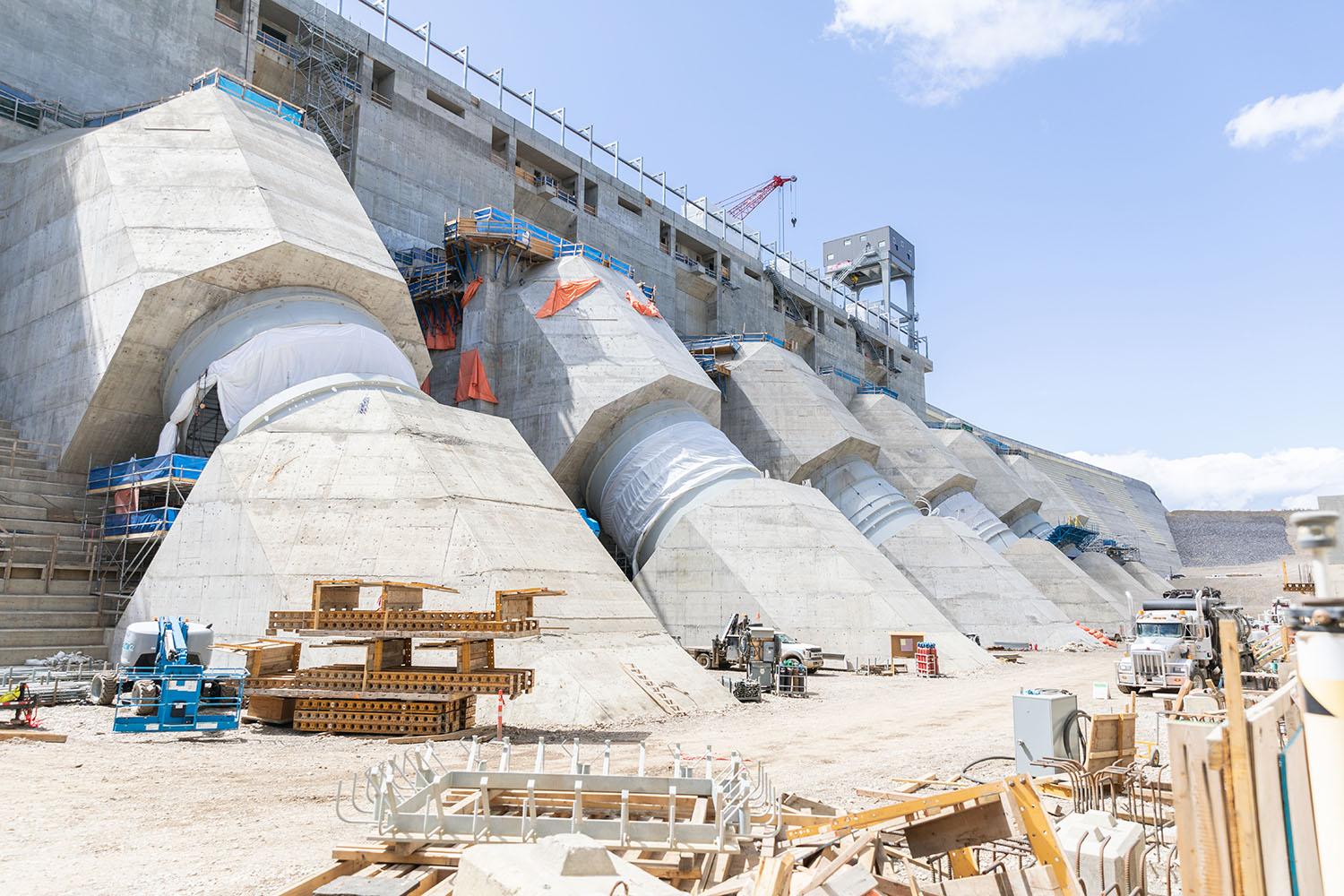 Looking west at the six penstocks where anchor bolts are being installed for the transmission tower base on penstock unit 5. | May 2023