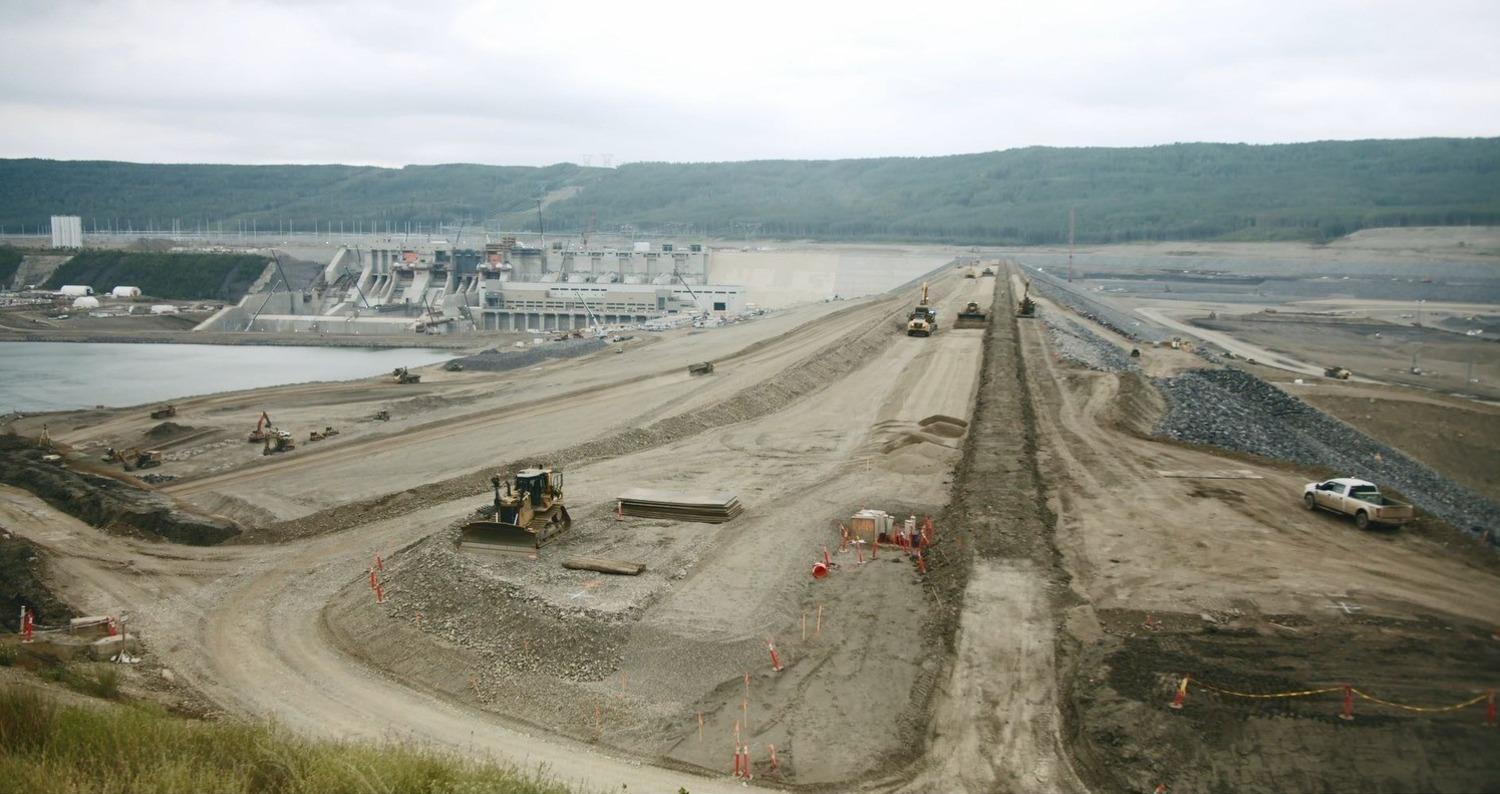 View of the completed earthfill dam and the powerhouse.