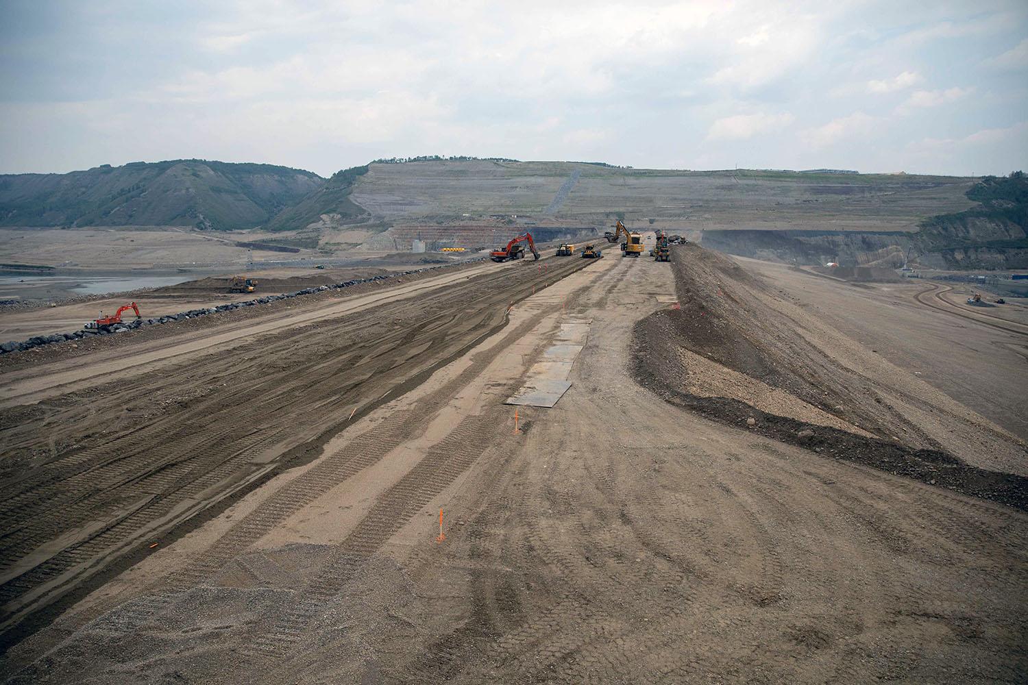 North-facing view across the earthfill dam as it nears completion. | June 2023