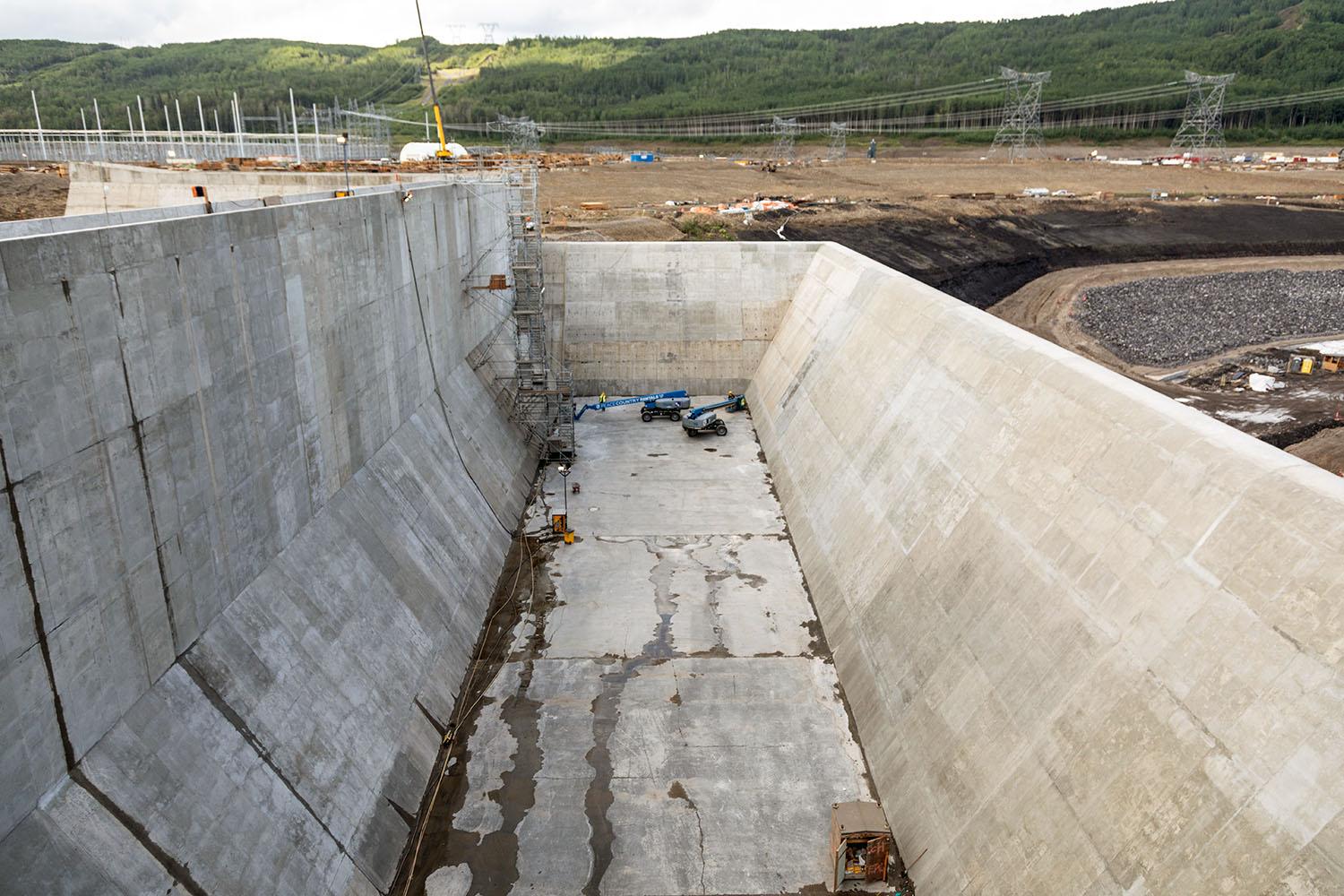 Concrete finishing will complete the basin of the auxiliary spillway. 