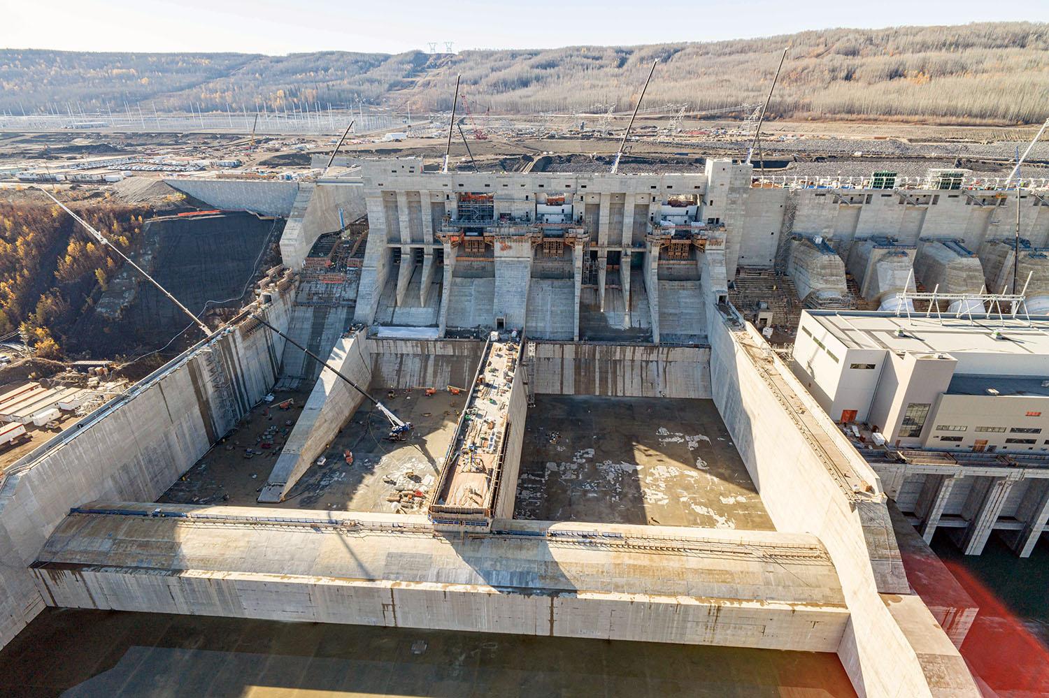 There are three spillways. The passive spillway at left can safely carry water from the approach channel in the unlikely event the two mechanical spillways lose power.