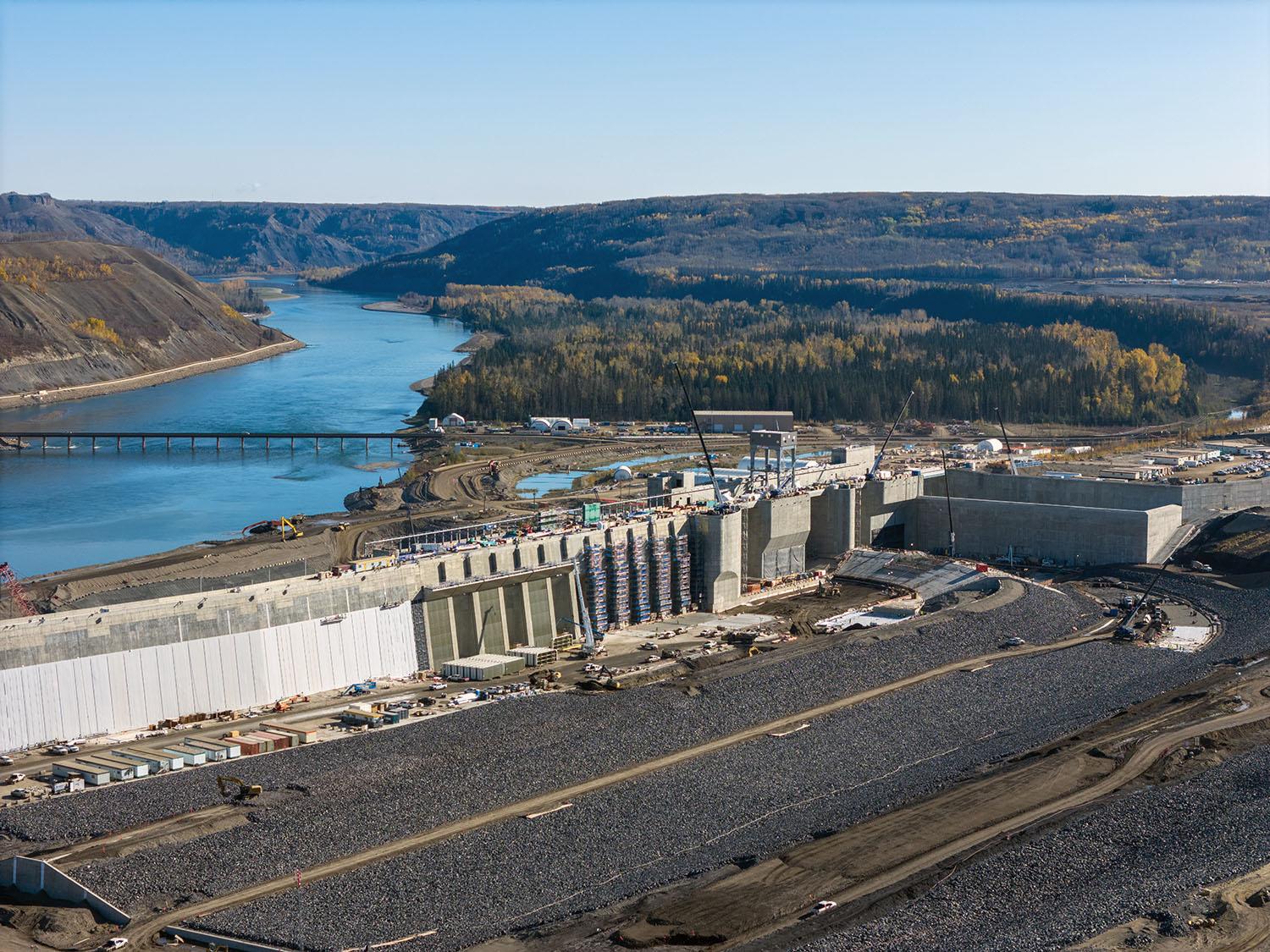 The approach channel carries water around the dam through the intakes at centre. The water travels through the intakes and down six penstocks to the turbine generating units.