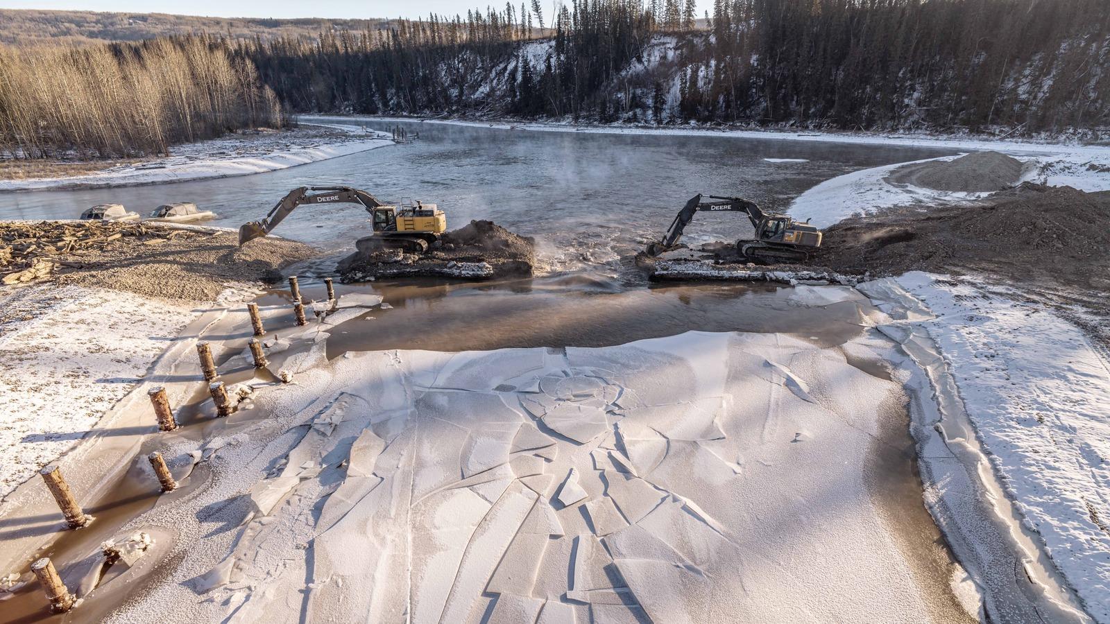 Removal of a causeway that blocked a channel during fish habitat construction is underway. Water from the river will gradually fill the channel.