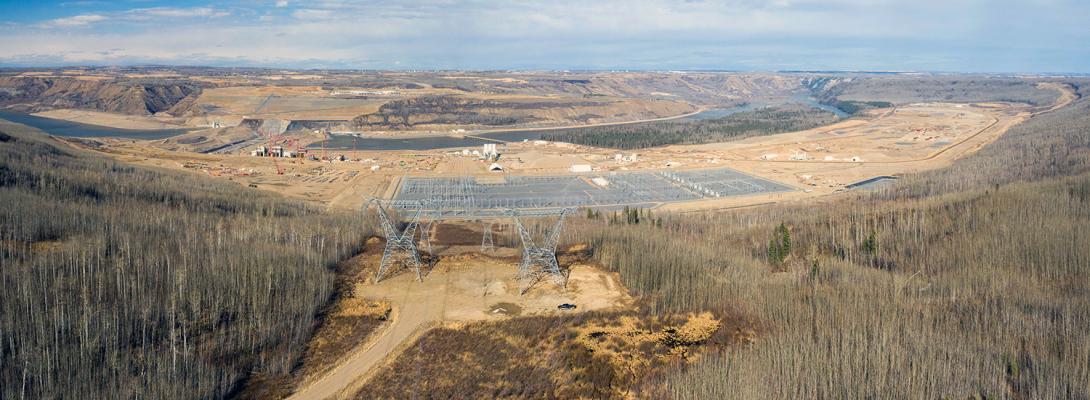 Transmission towers for two new transmission lines stand side-by-side above the completed Site C substation. | April 2021