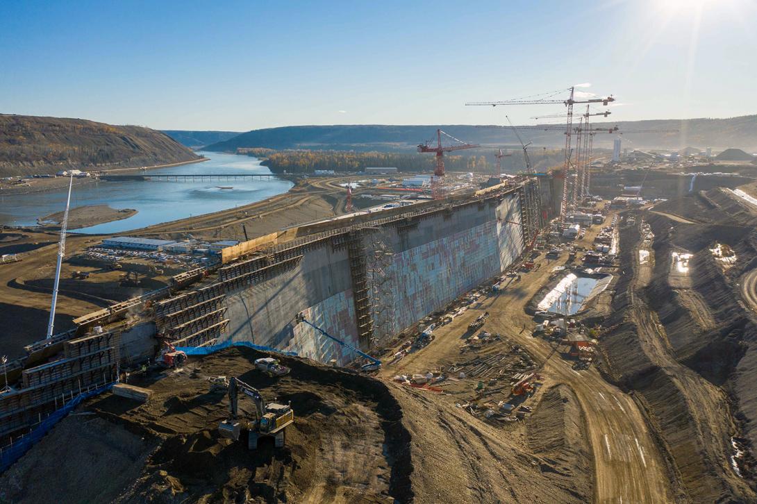 Roller-compacted concrete ramps are removed from the dam core buttress and insulation is installed on the upstream side of the buttress.  | October 2021