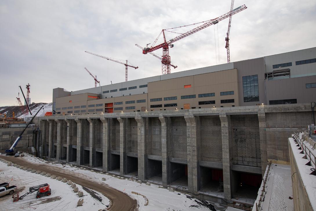 The powerhouse and tailrace. Crews recently completed construction of the powerhouse building; attention now turns to finishing the installation of the turbine-embedded parts and interior fixtures. | December 2021