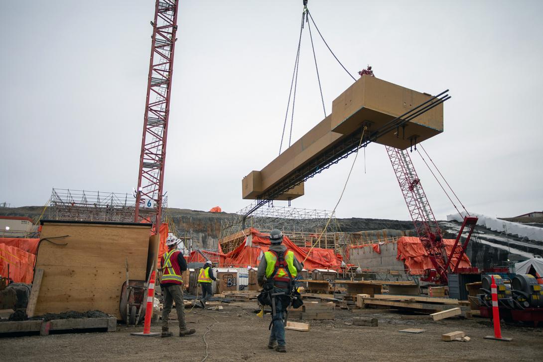 Crews use a crane to lift formwork for placement at the spillway headworks. | April 2021