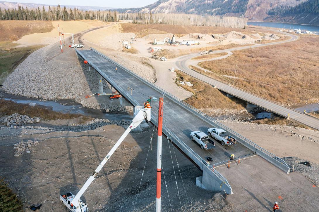 Installing the power poles for the distribution line crossing at Lynx Creek. | October 2022