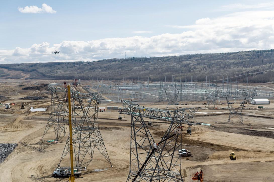 A drone is used instead of a helicopter to install a pulling line. This line pulls wires to connect the Site C substation to the dam and generating station. | May 2024