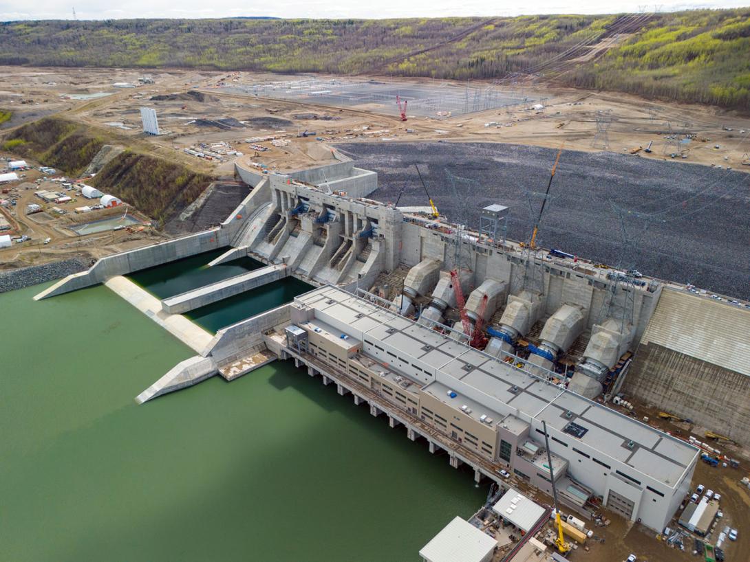 Stringing has started to connect the three transmission towers on the penstocks to the Site C substation. Three 500-kilovolt lines cross the approach channel. | May 2024