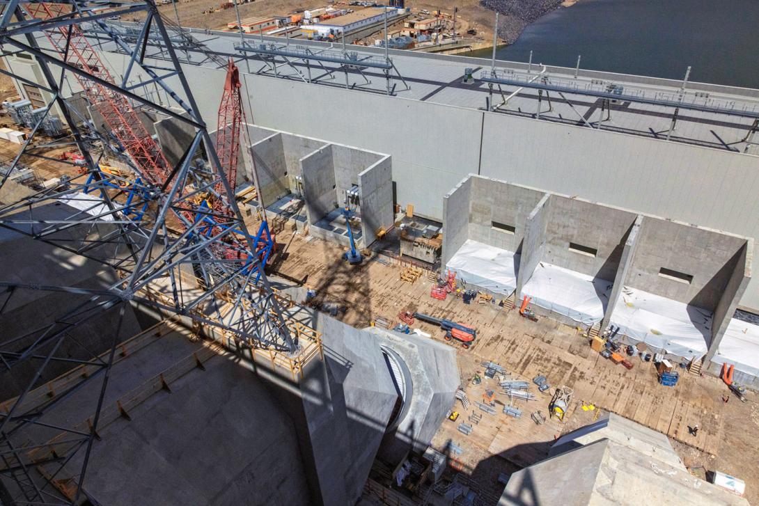 Three sets of three completed protection walls where the step-up transformers will be located. Each transformer will step up the voltage from the generators from 13,700 volts to 500,000 volts. | June 2024