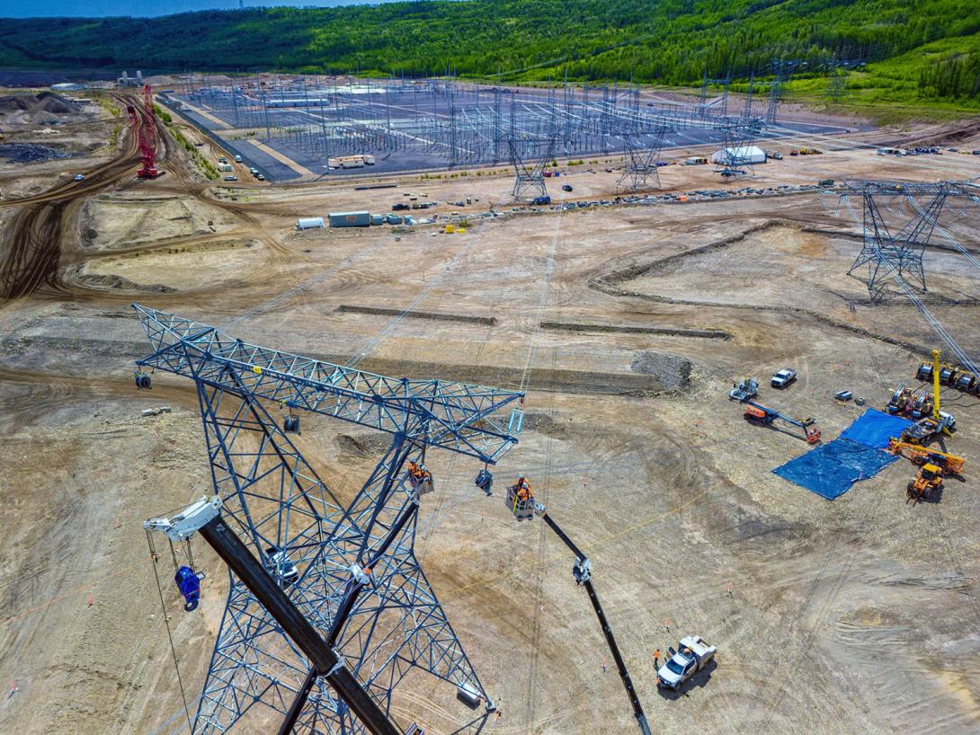 Powerline technicians install the conductor on the last of three towers. | June 2024