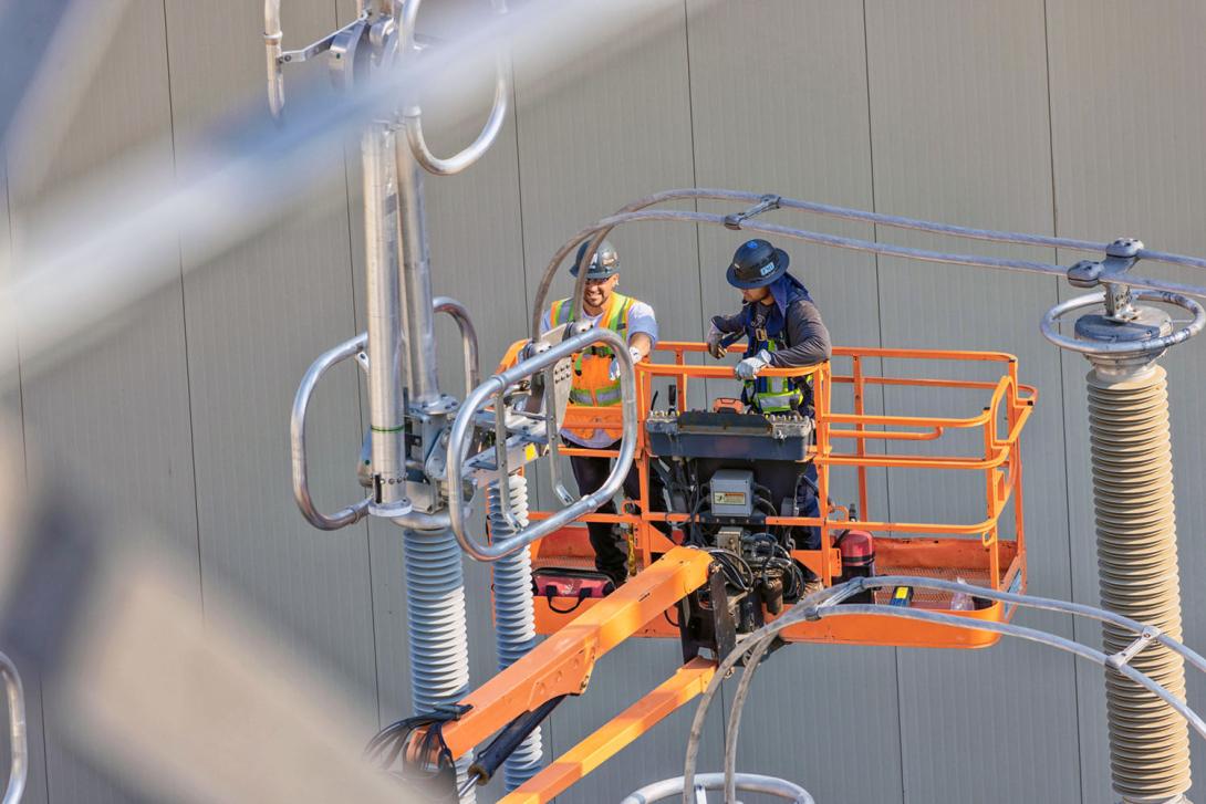 Technicians completing the connections for the first set of three step-up transformers. | July 2024