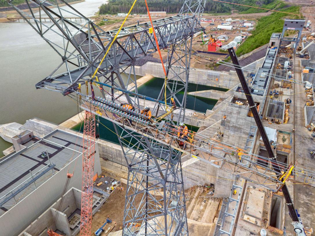 Powerline technicians are positioning the dead-end glass in preparation to dead-end the conductor. | June 2024