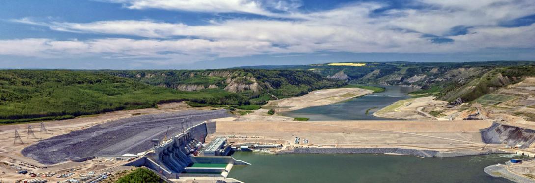 An upstream view of Site C. From left, the approach channel, powerhouse and generating station, and the dam. | July 2024