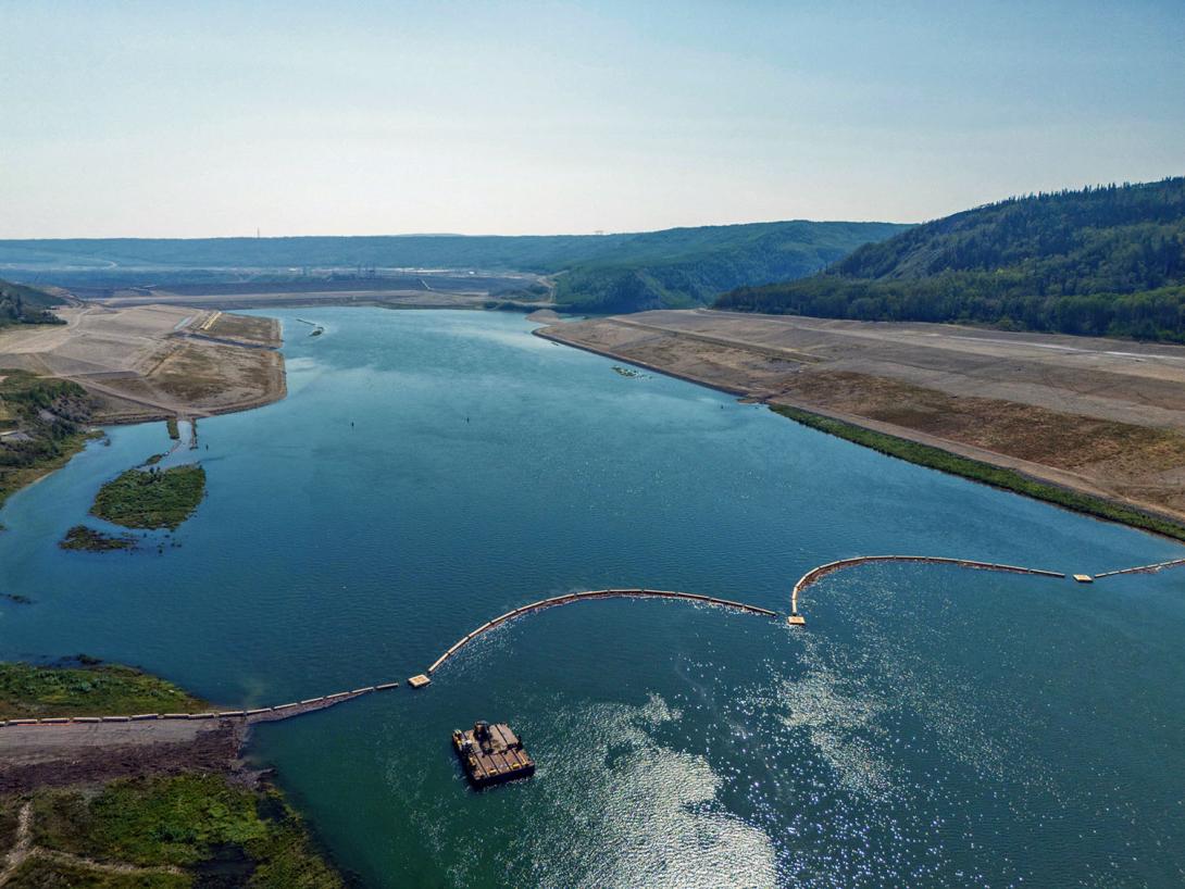 Downstream view of the Site C dam at the debris boom and barge. | August 2024